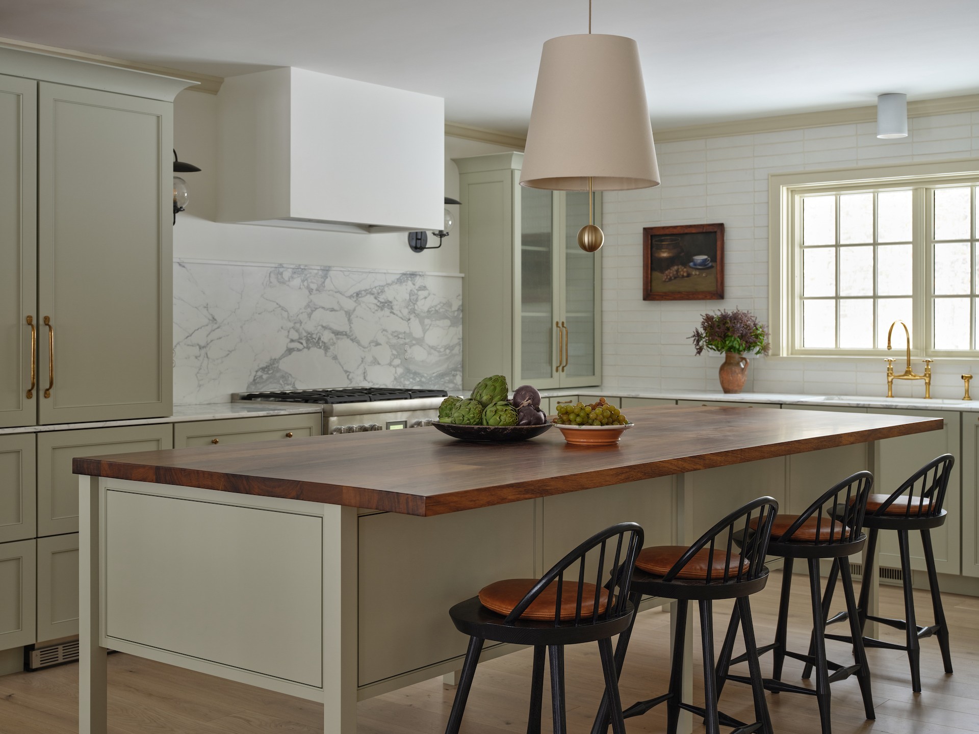 a kitchen with a center island with four stools