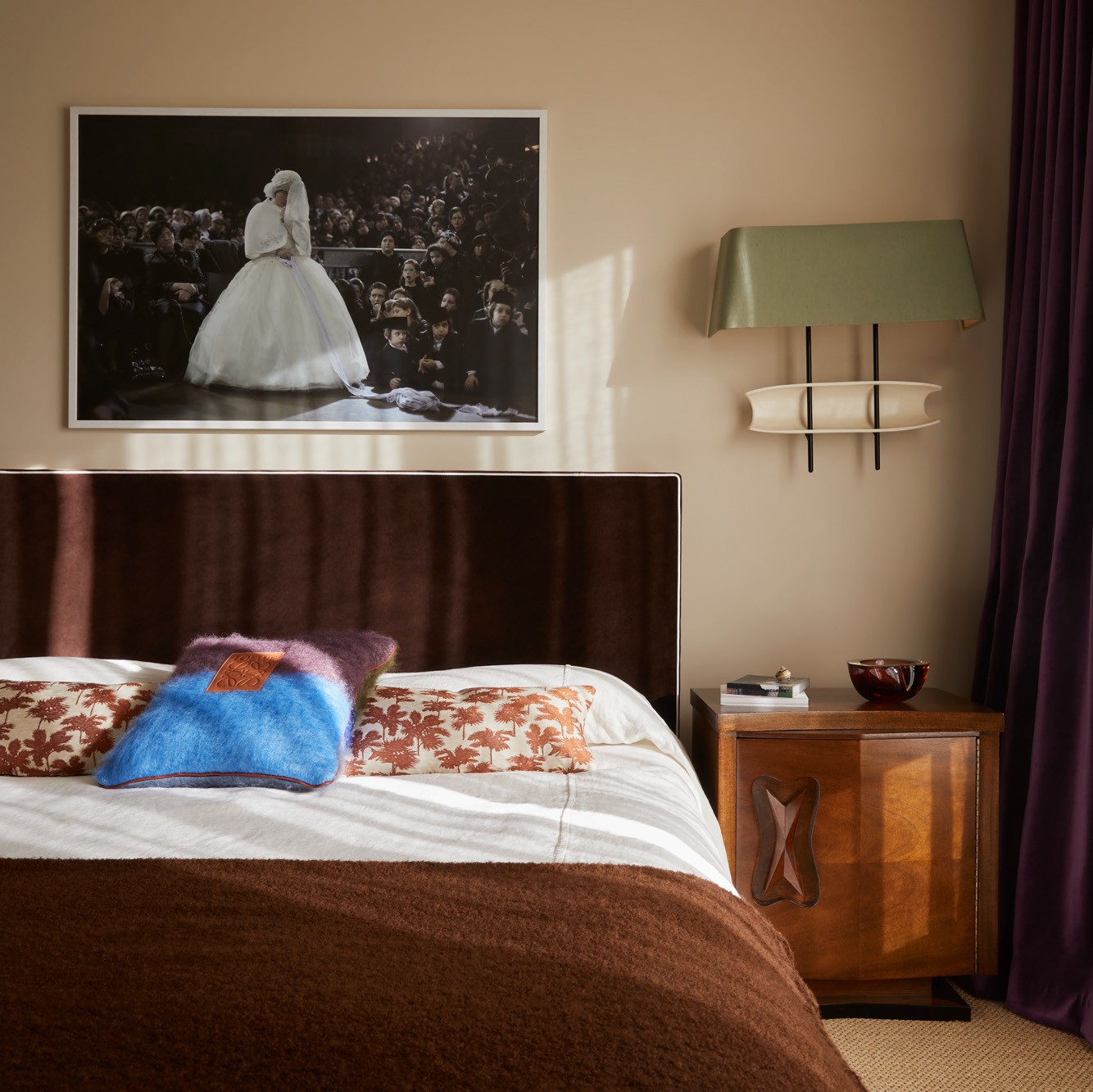 a bed in a bedroom with a picture on the wall