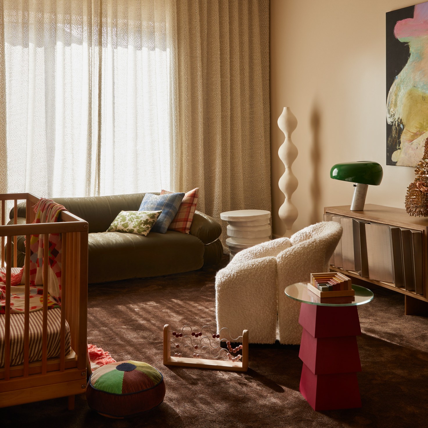 a living room filled with furniture and a baby crib