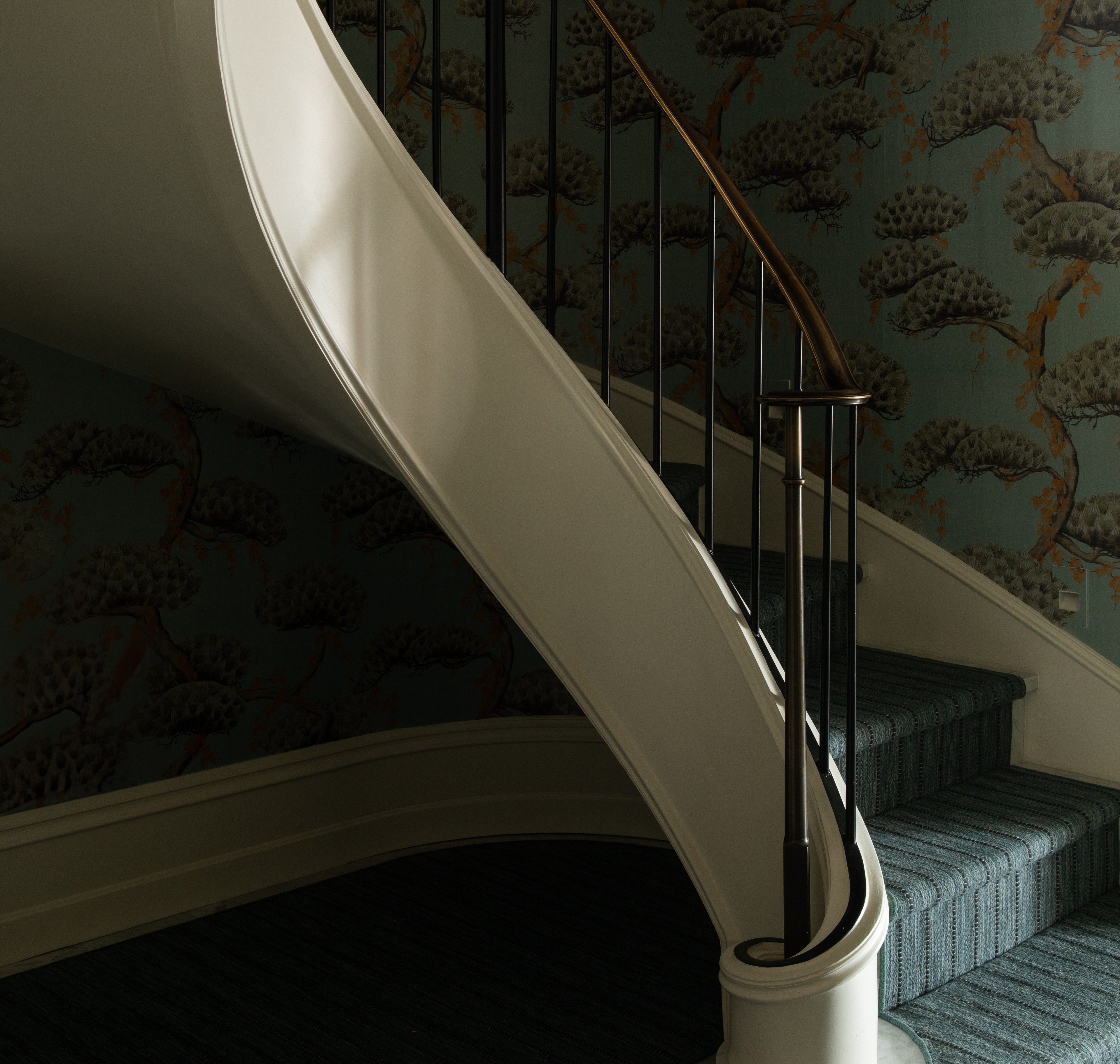 a staircase with a wallpapered wall next to it