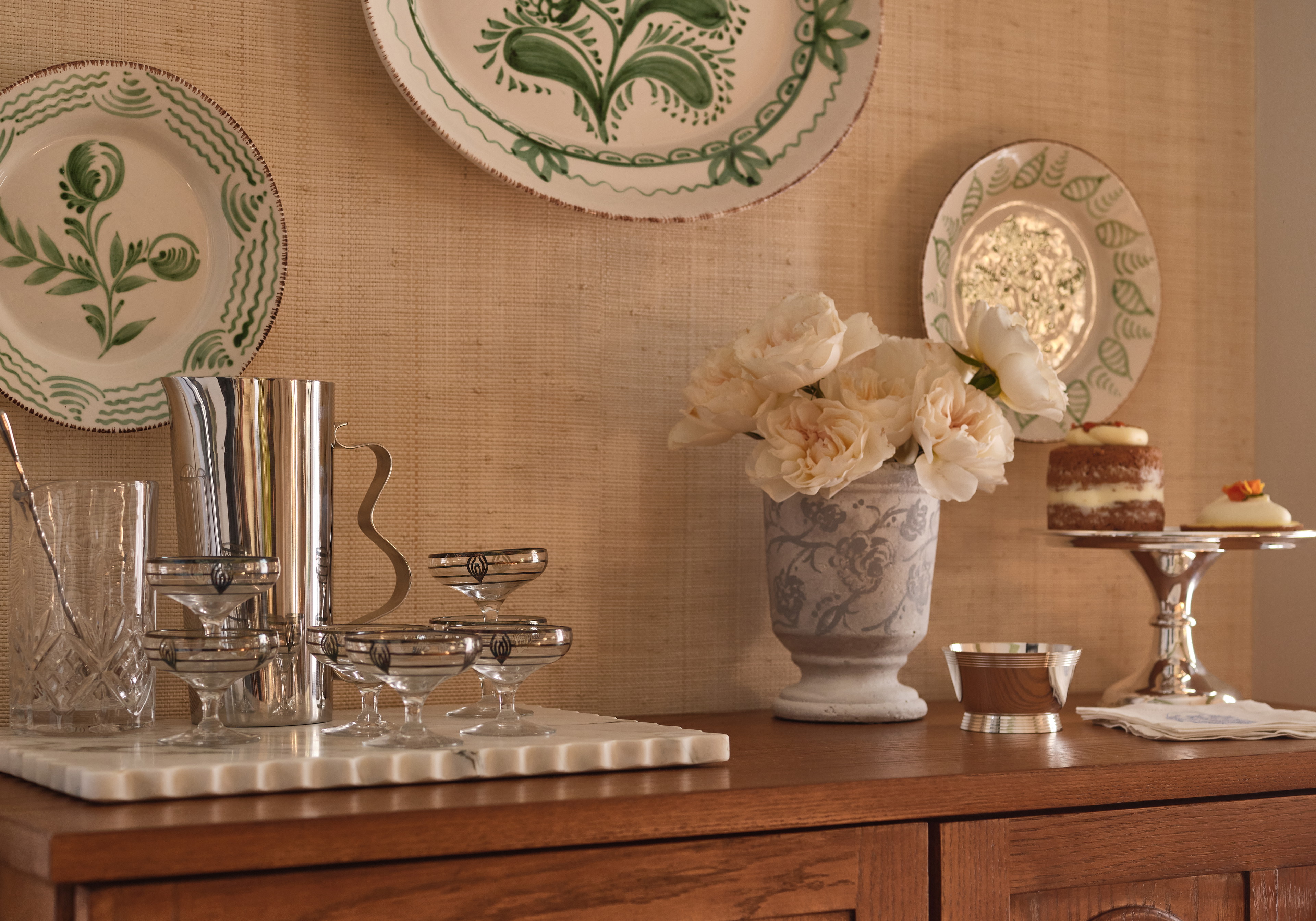 a table with plates and a vase of flowers on it