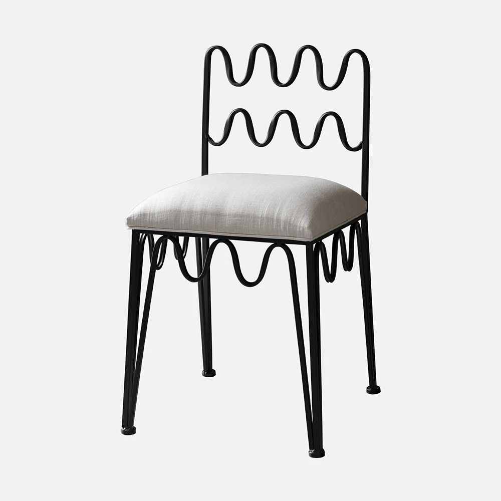 a black chair with a white cushion on top of it