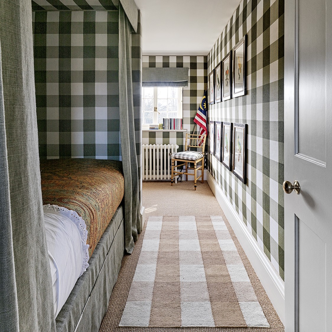 a bedroom with a checkered wall and a bed