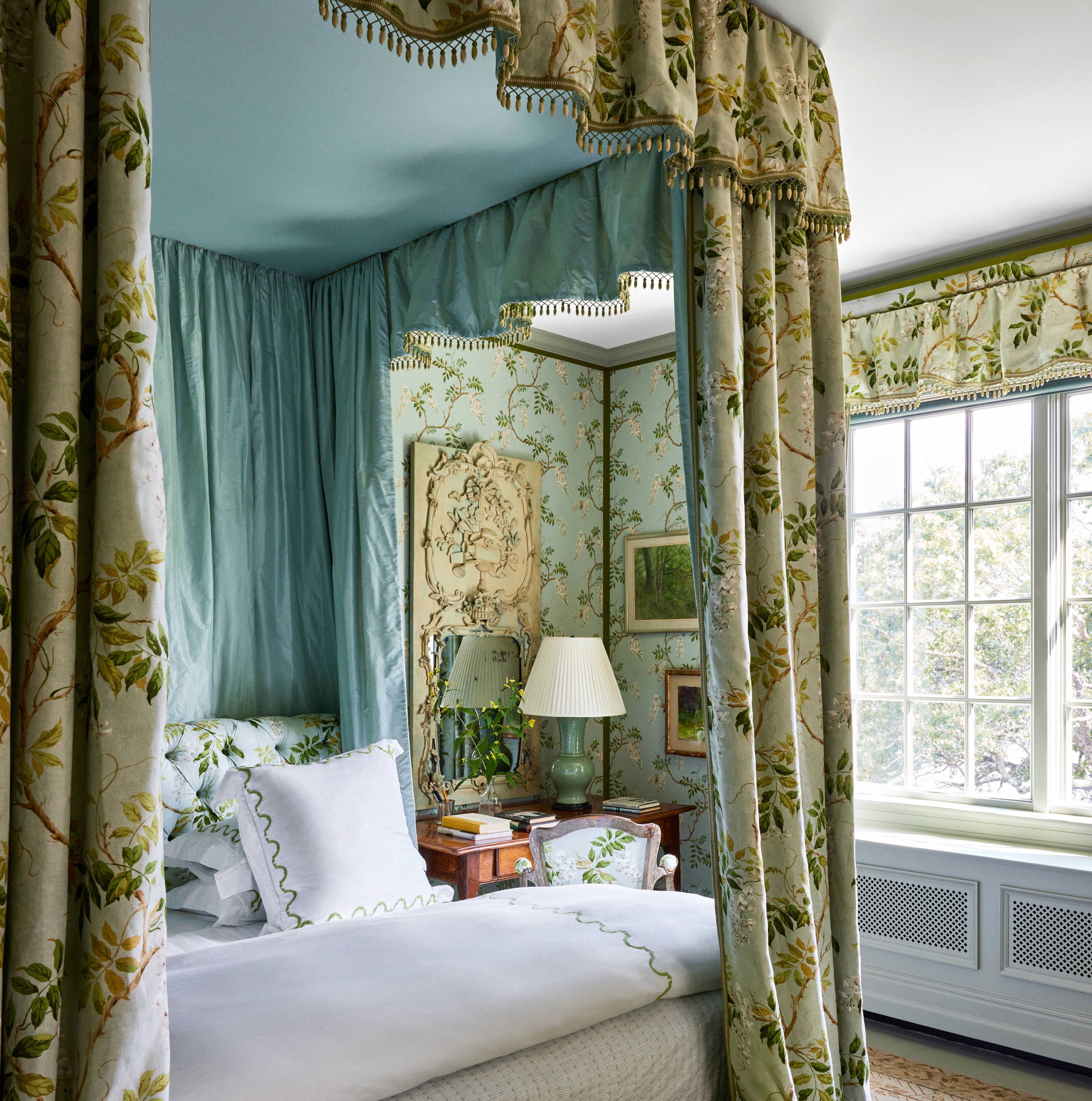 a bedroom with a canopy bed and a green bench