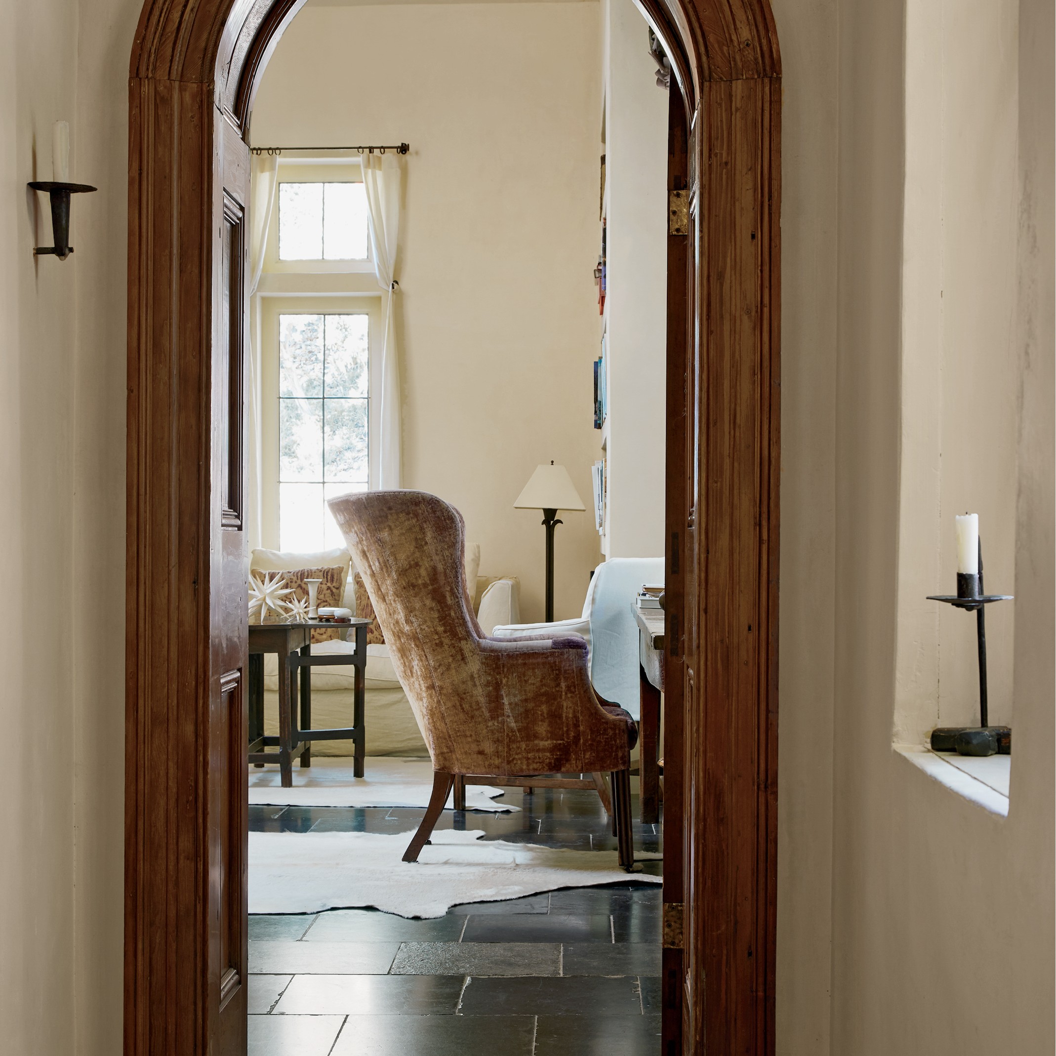 a large arched doorway leading to a living room