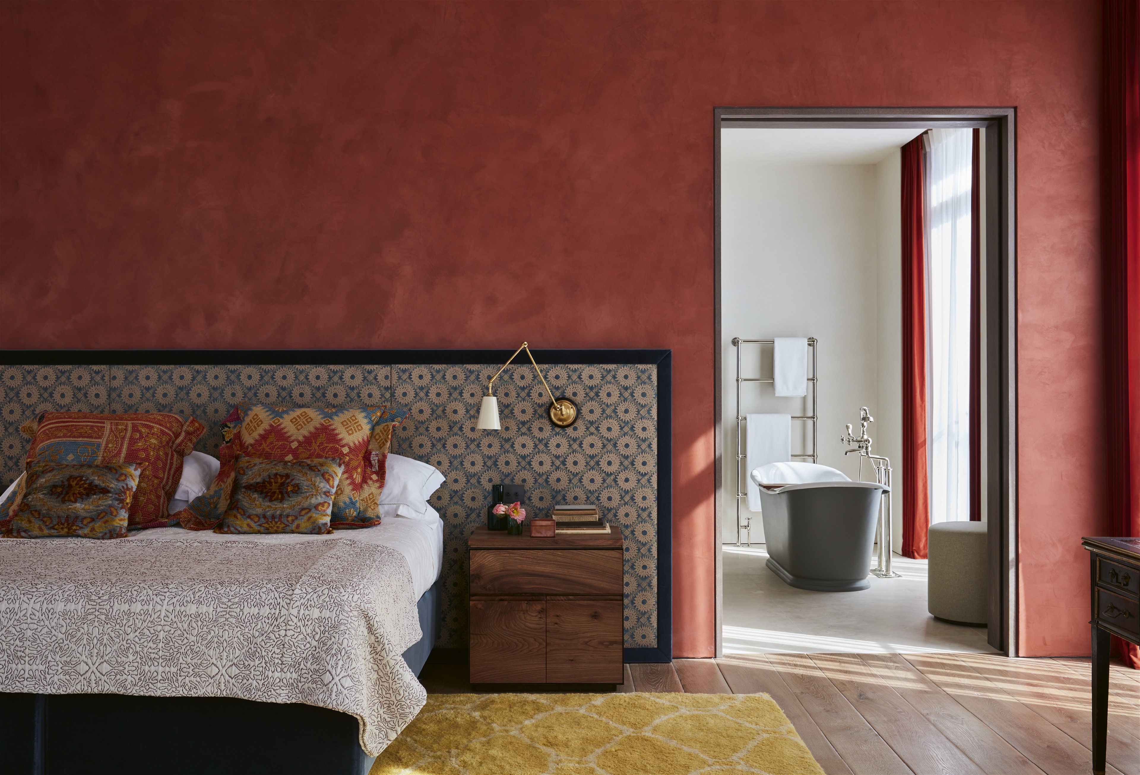 a bedroom with red walls and a bed