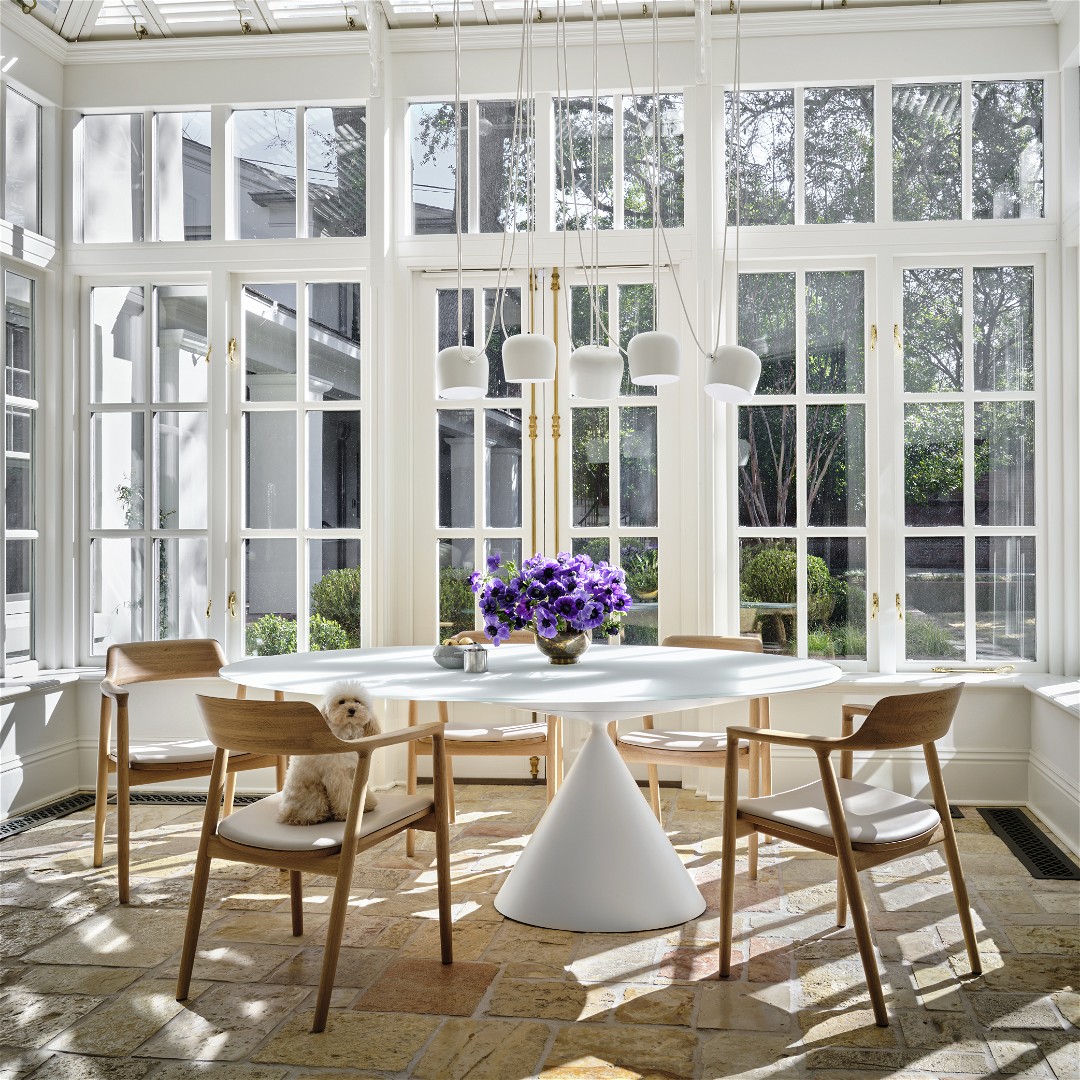 a dining room with a white table and chairs