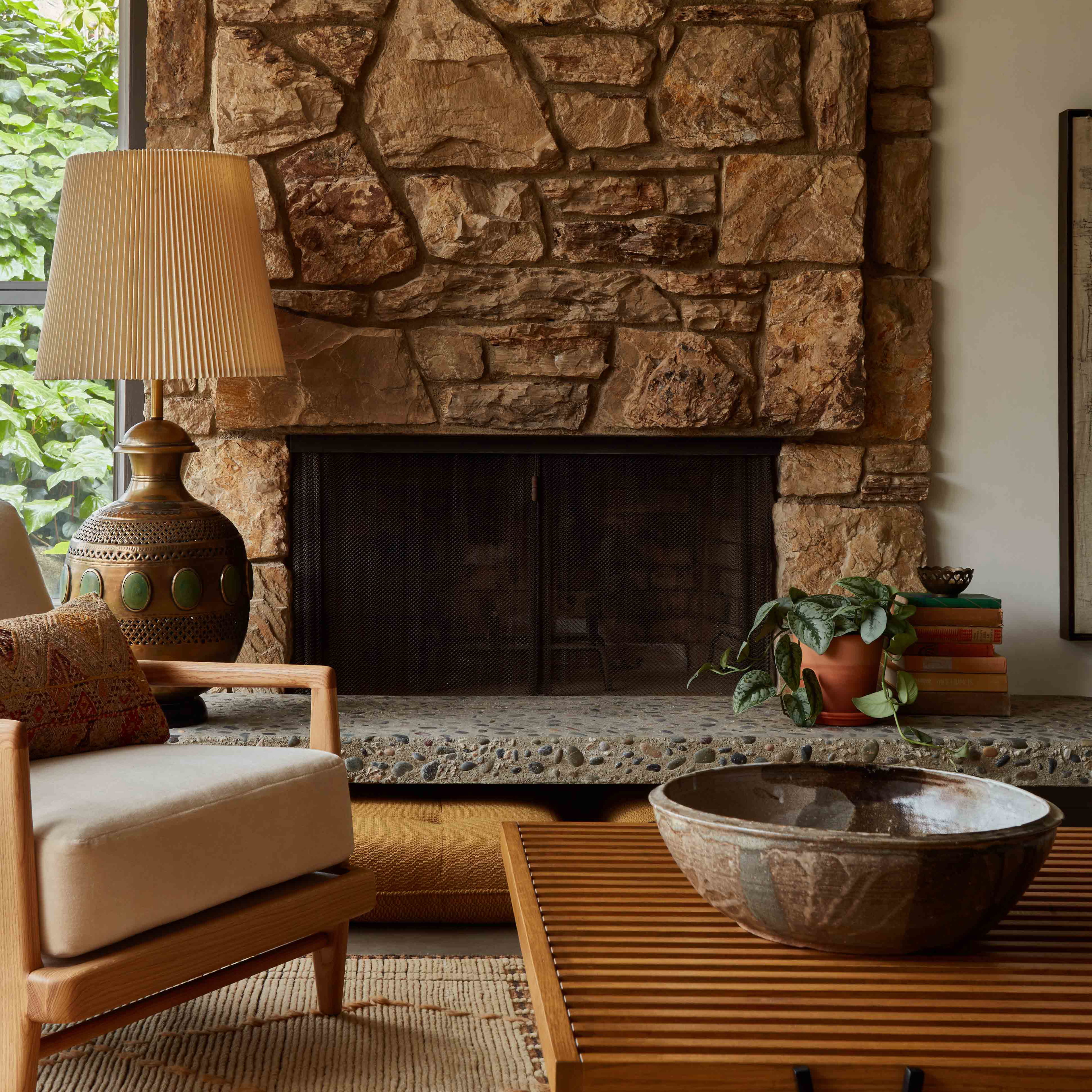 a living room with a large stone fireplace
