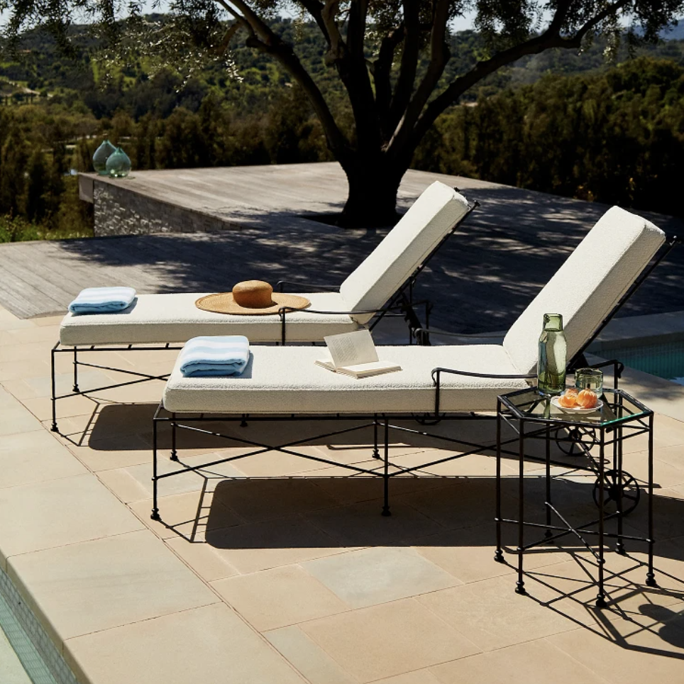 a couple of lounge chairs sitting next to a pool
