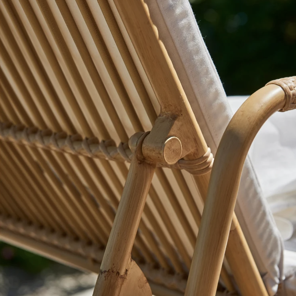 a close up of a wooden lawn chair