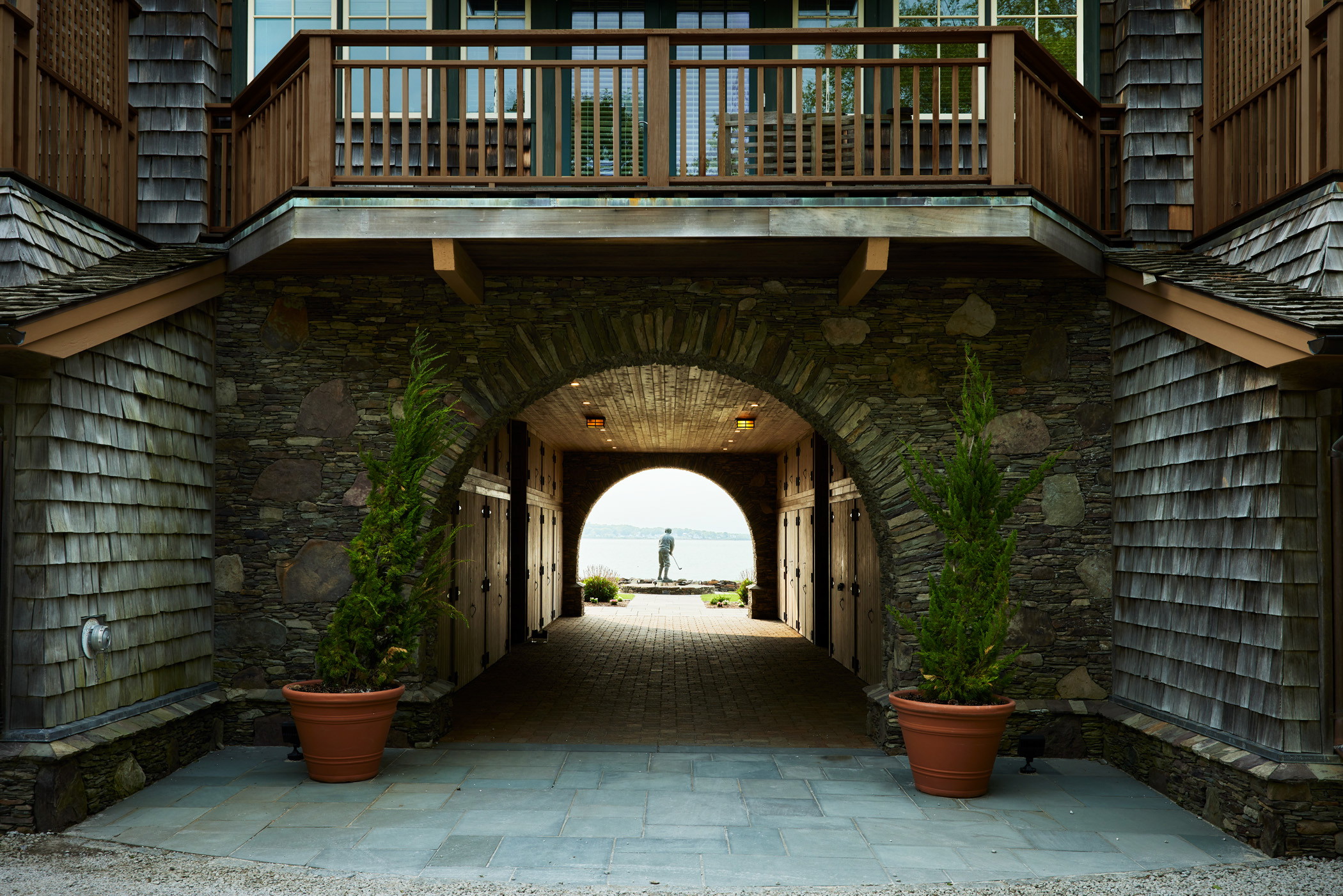 a stone building with a walkway leading to a balcony