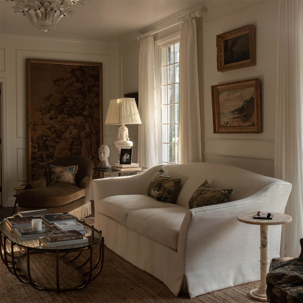 a living room filled with furniture and a chandelier