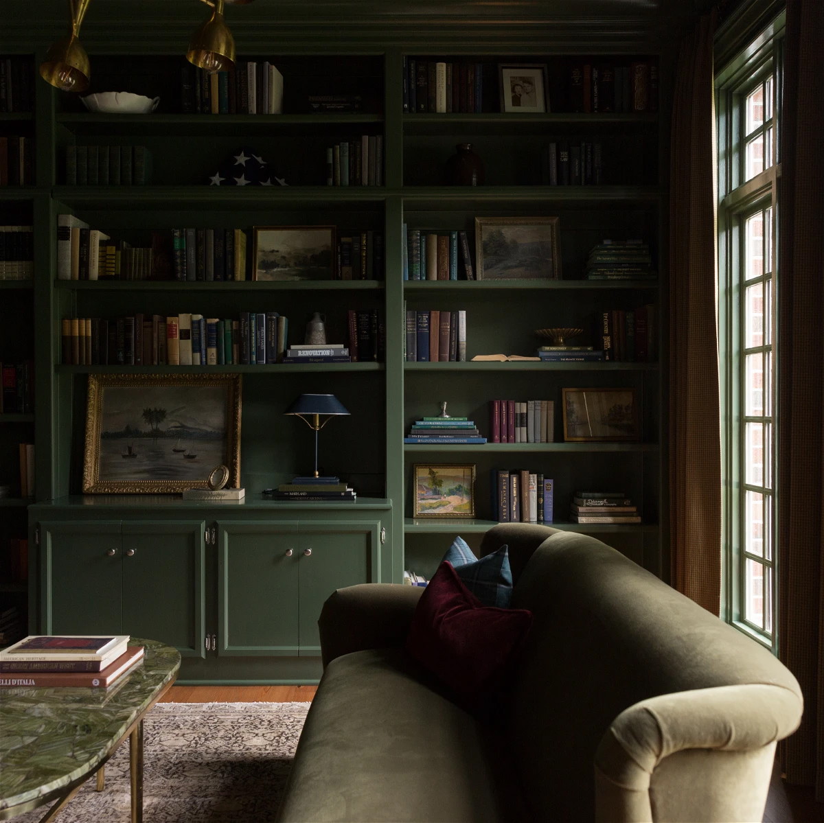 a living room filled with furniture and a book shelf