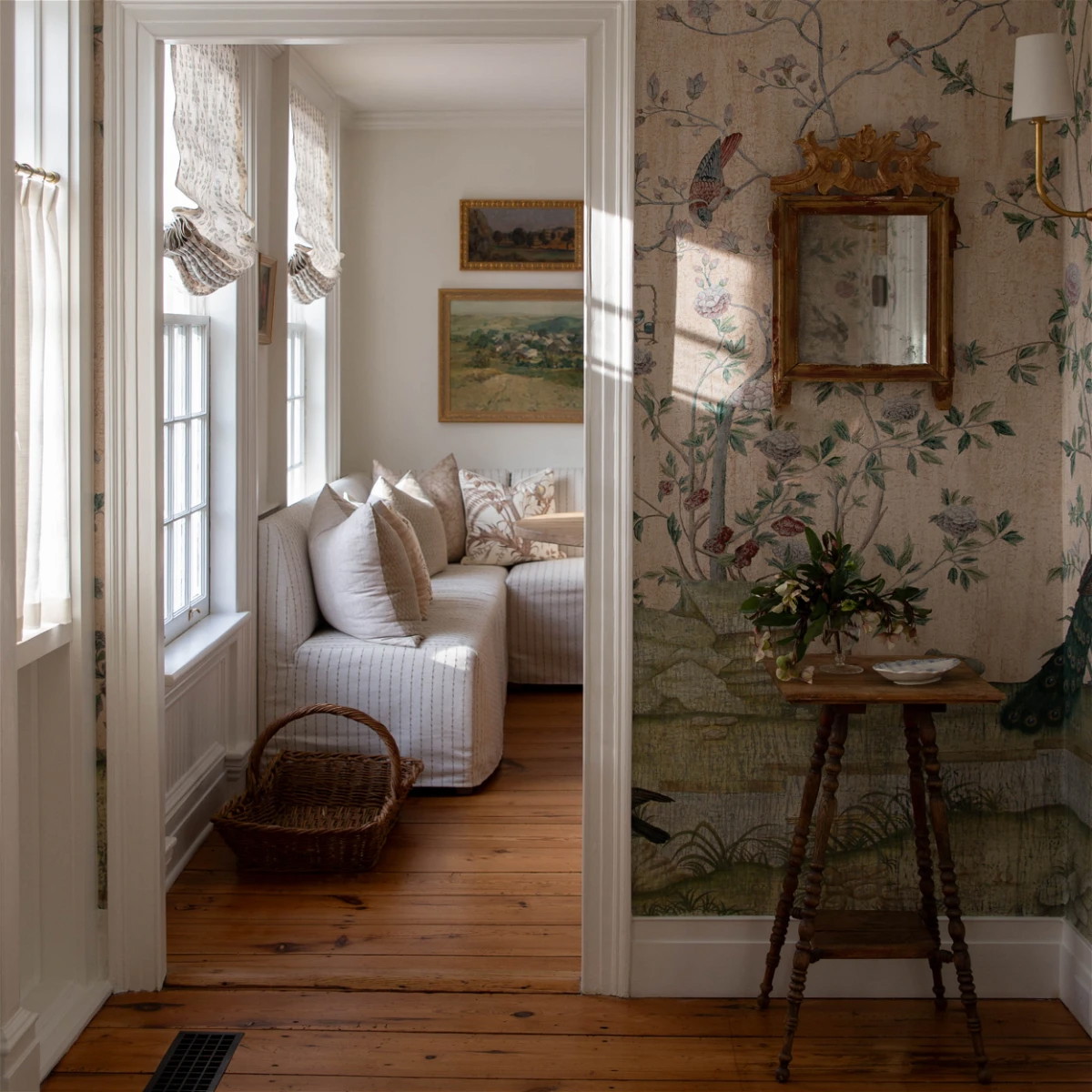 a living room filled with furniture and a mirror