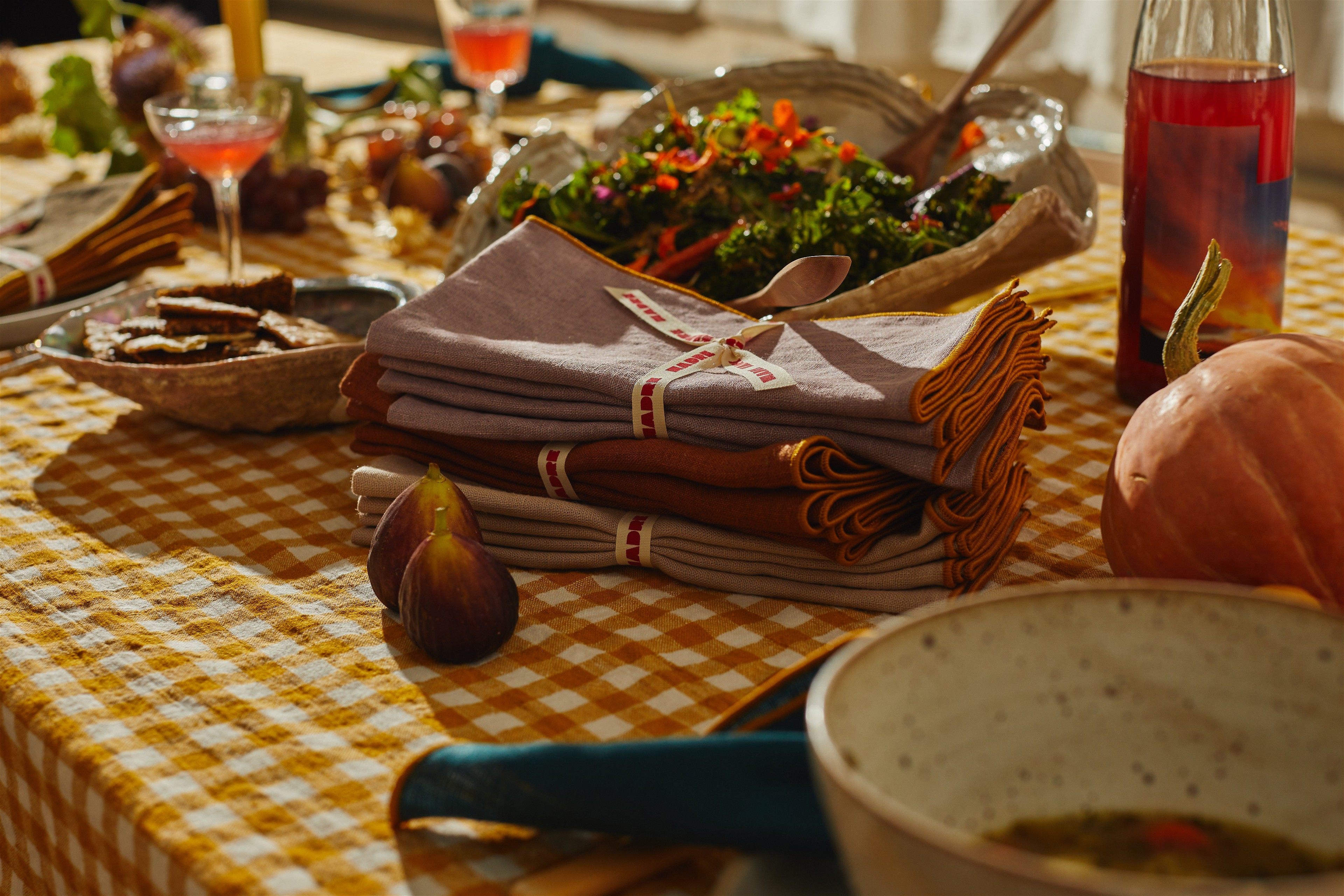 a table topped with plates of food and a bowl of salad