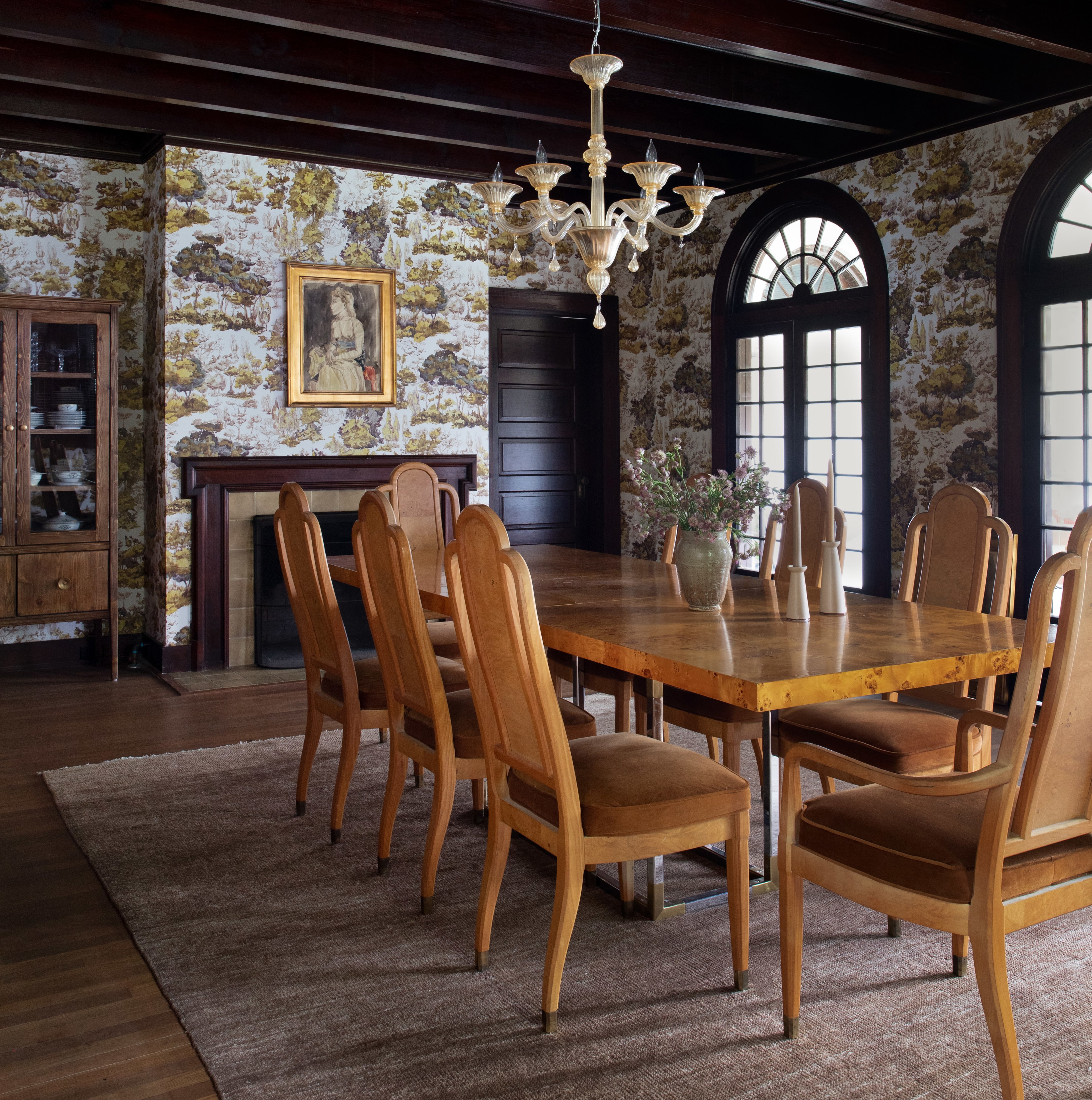 a dining room table with chairs and a chandelier