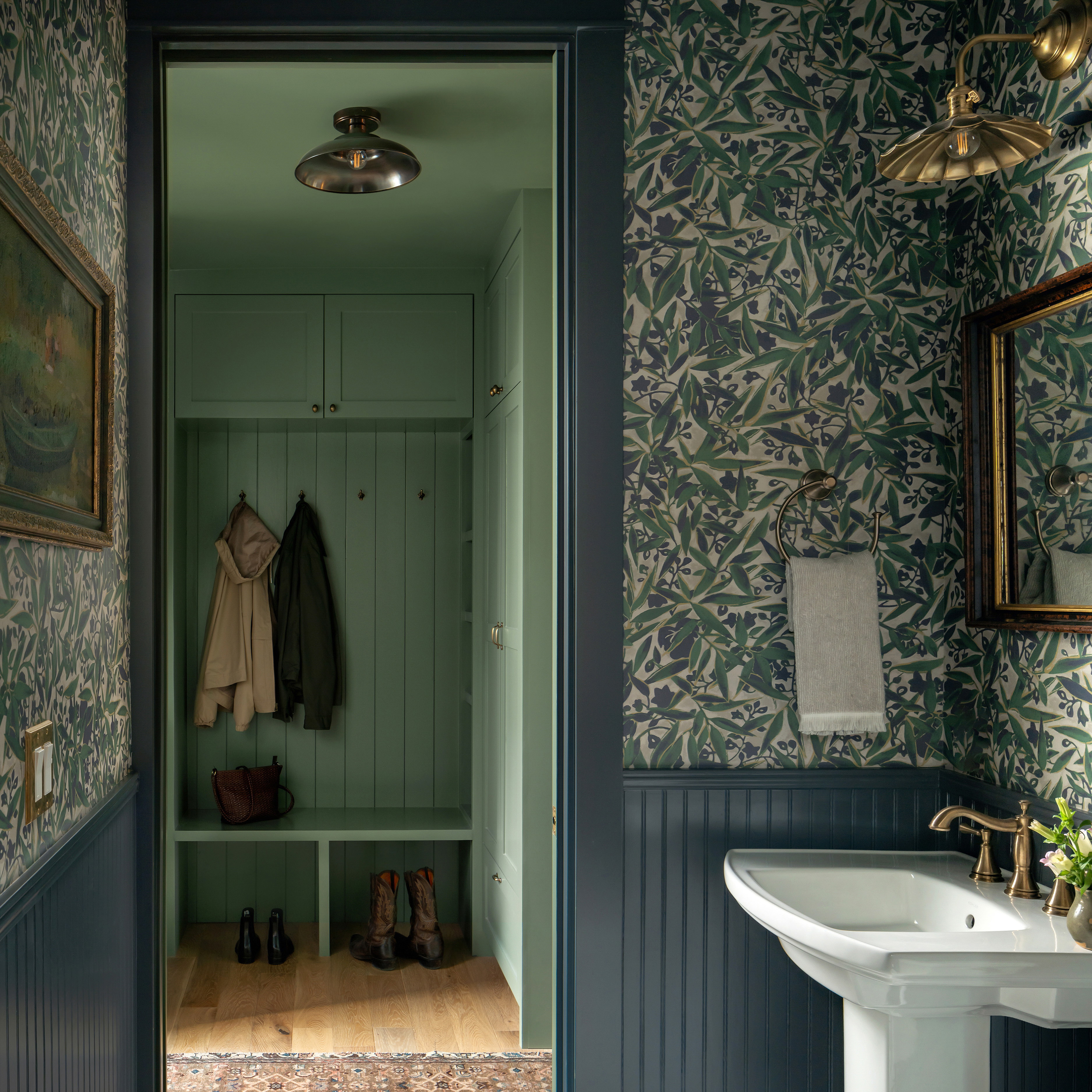 a bathroom with a sink, mirror and coat rack