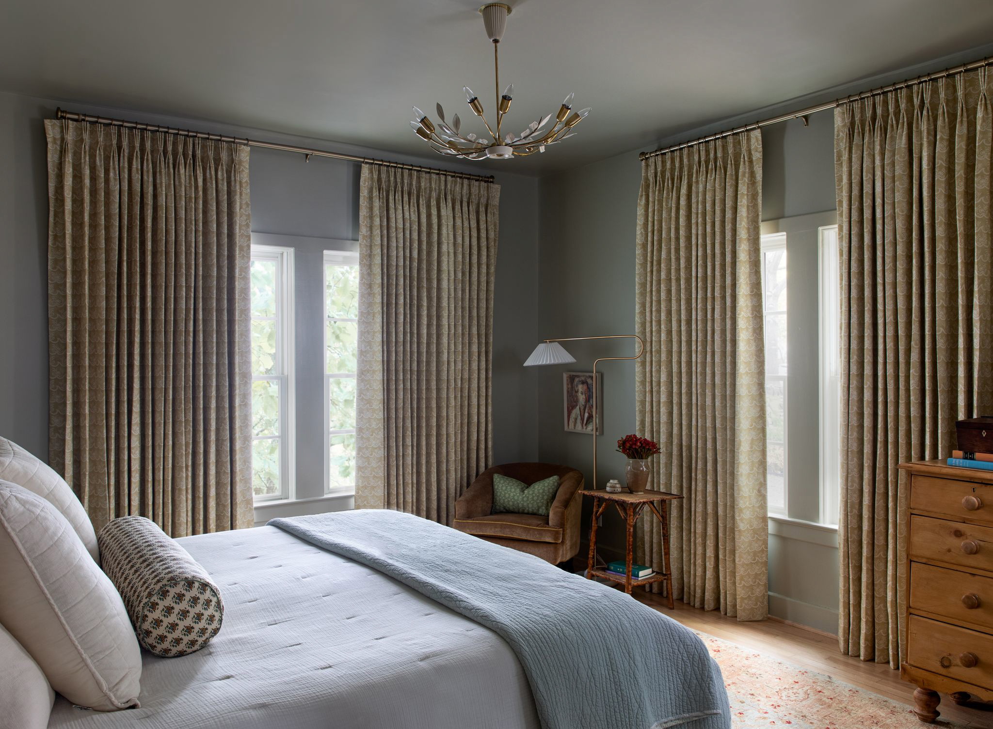 a bedroom with a chandelier and a bed