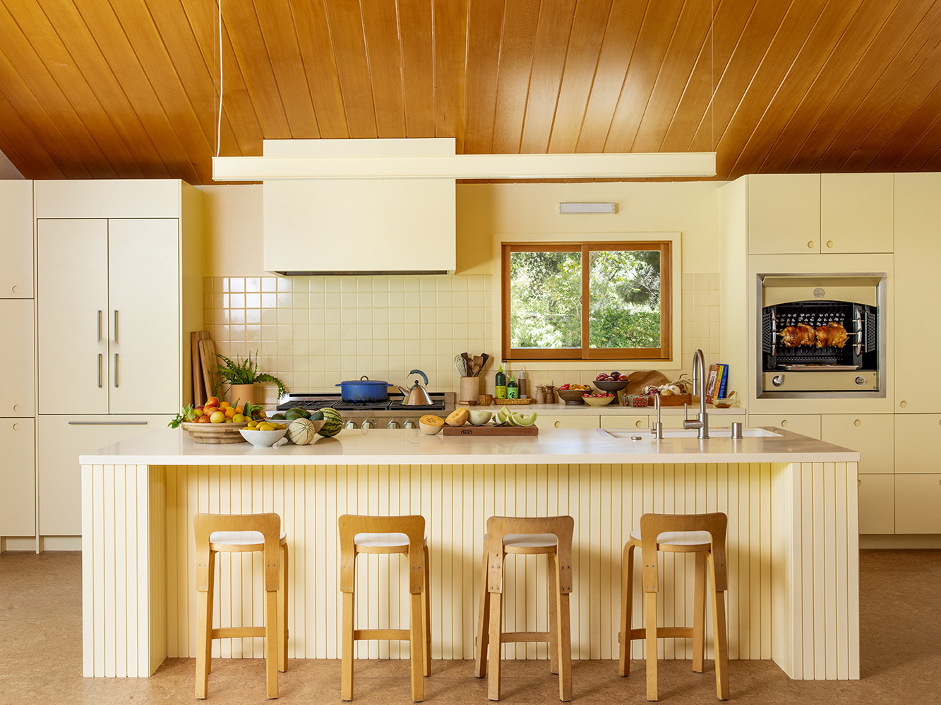 a kitchen with a center island and three stools