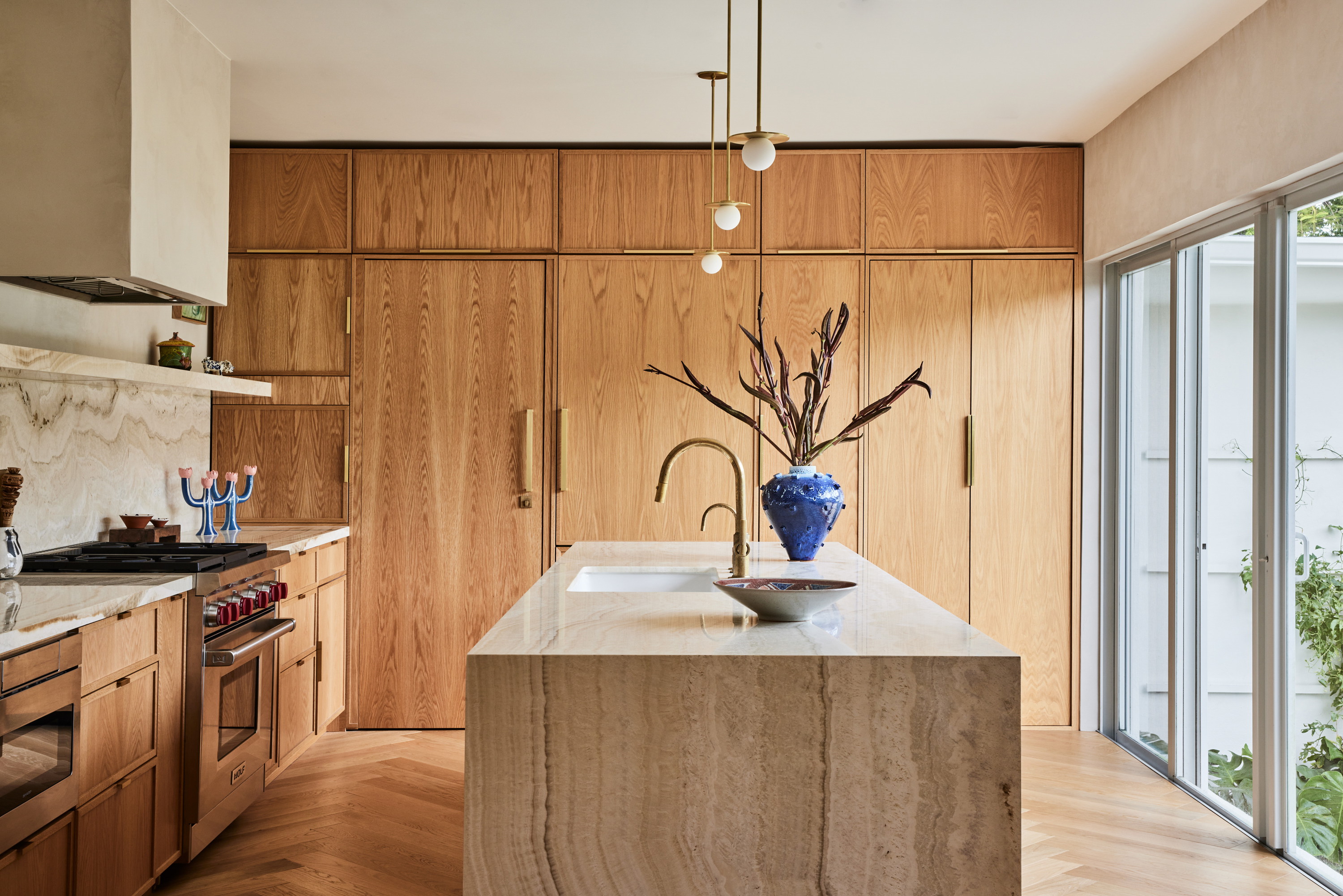 a kitchen with wooden cabinets and a marble counter top