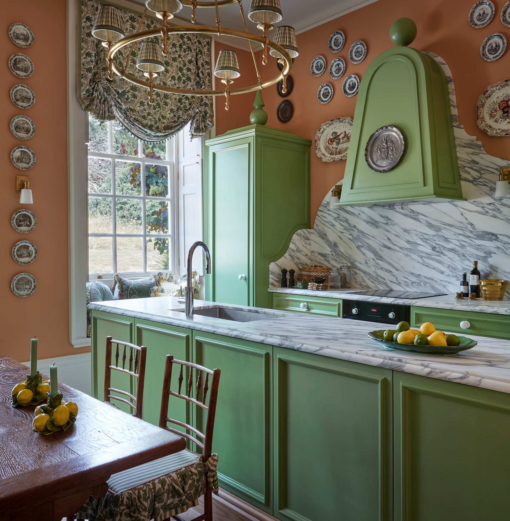 a kitchen with green cabinets and a chandelier