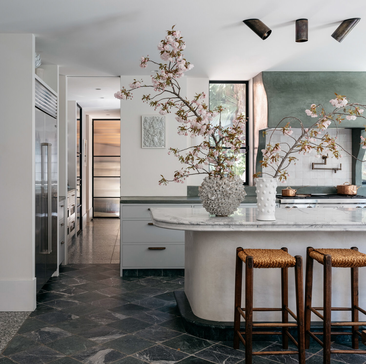 a kitchen with a center island and two stools