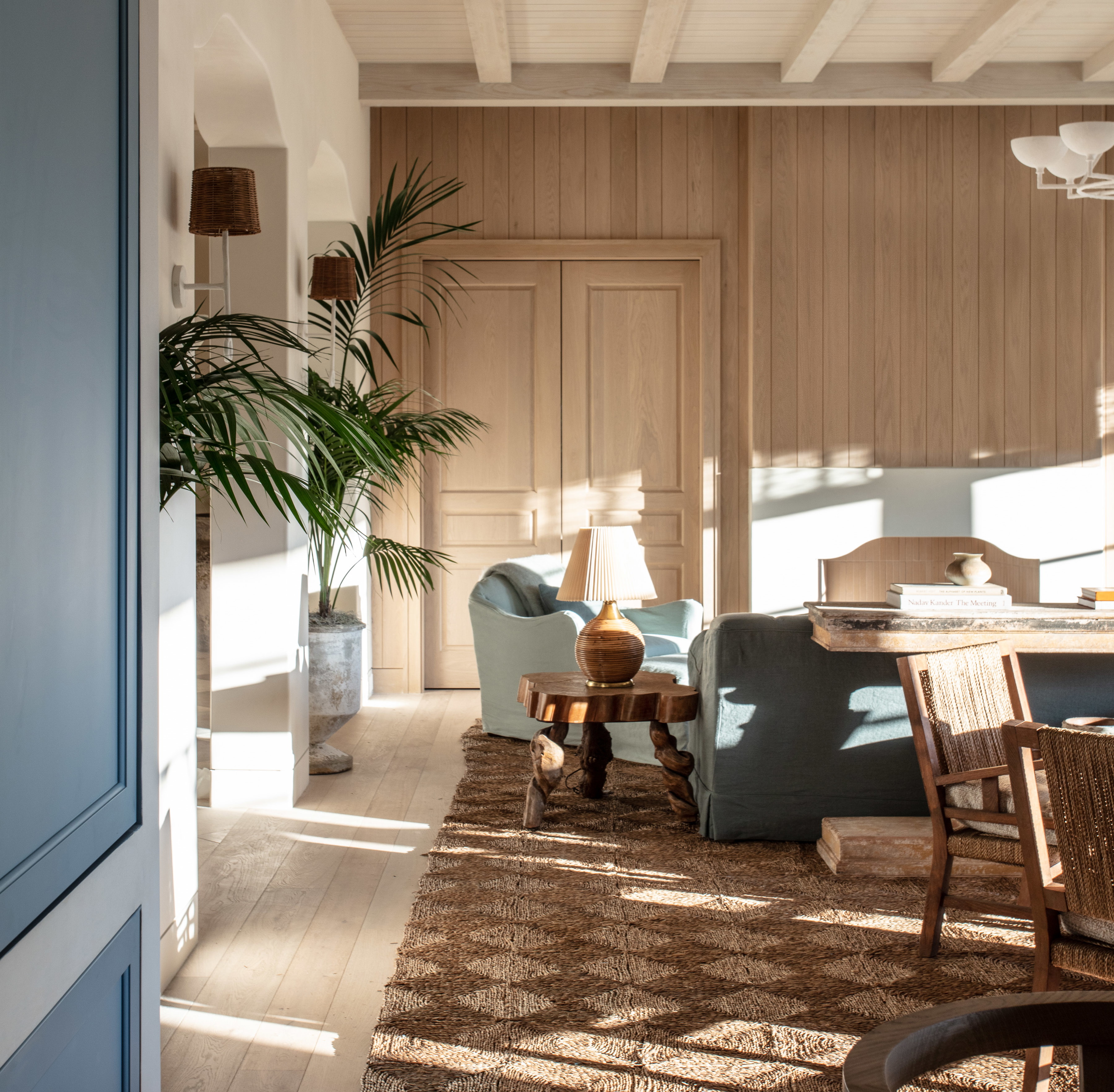 a living room filled with furniture and a dining room table