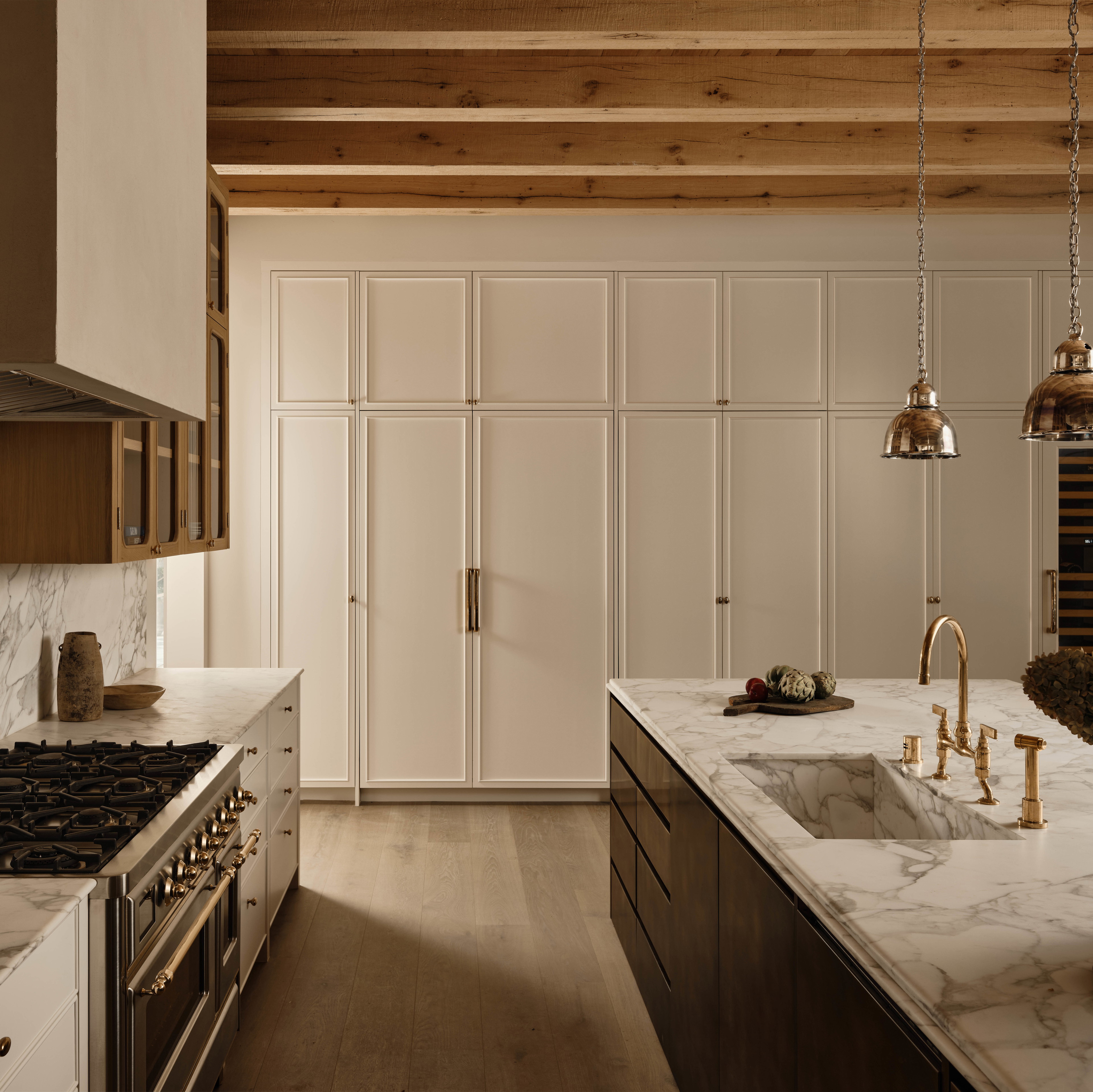 a kitchen with marble counter tops and wooden cabinets