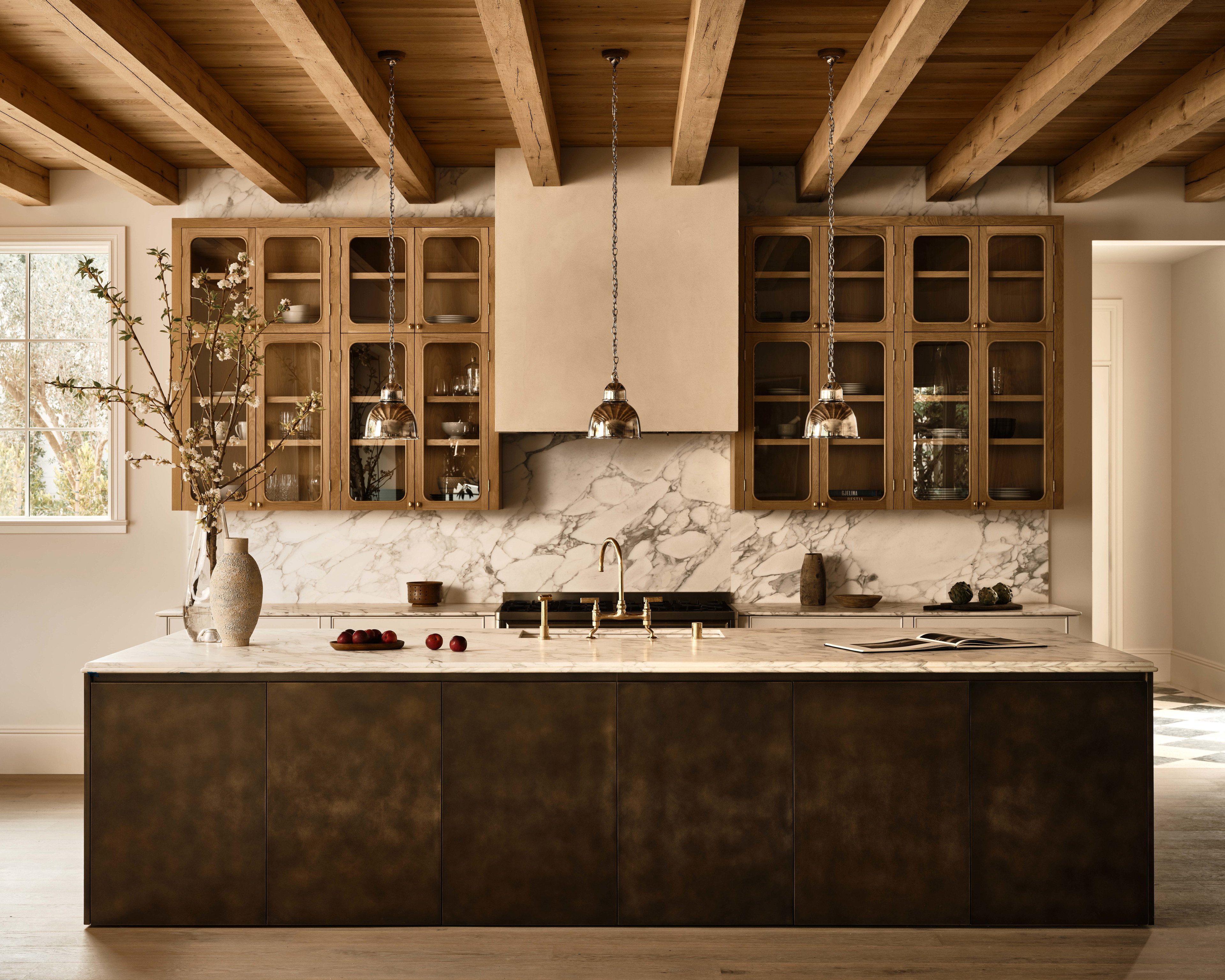 a kitchen with a marble counter top and wooden cabinets