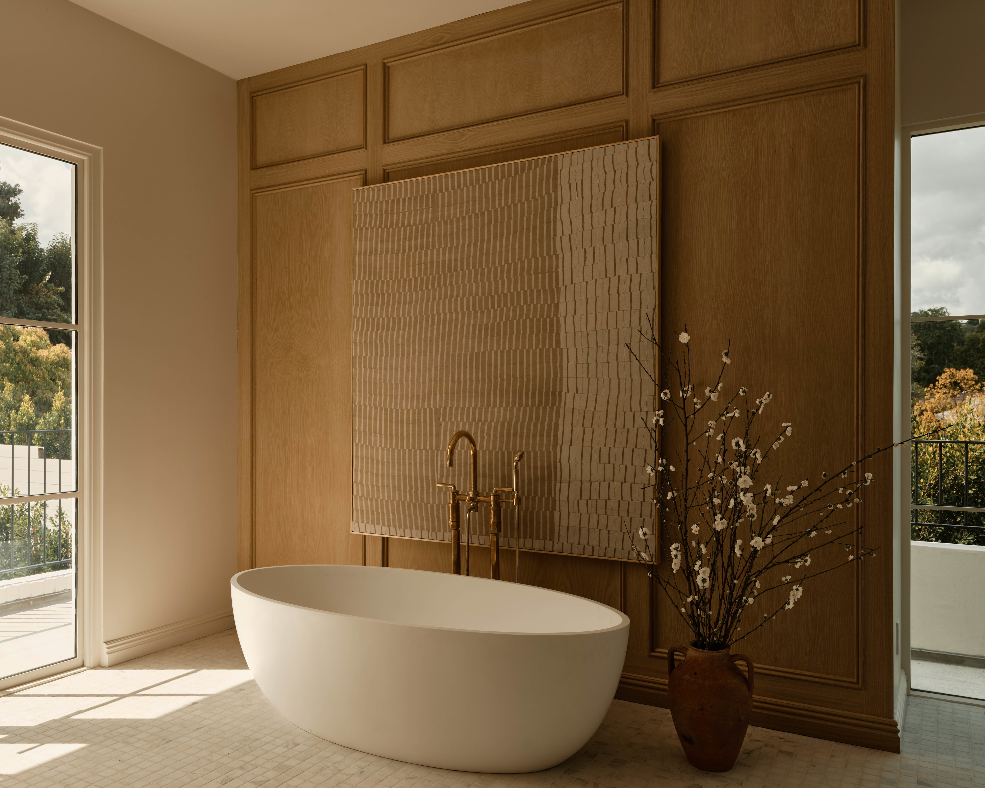 a large white bath tub sitting next to a window