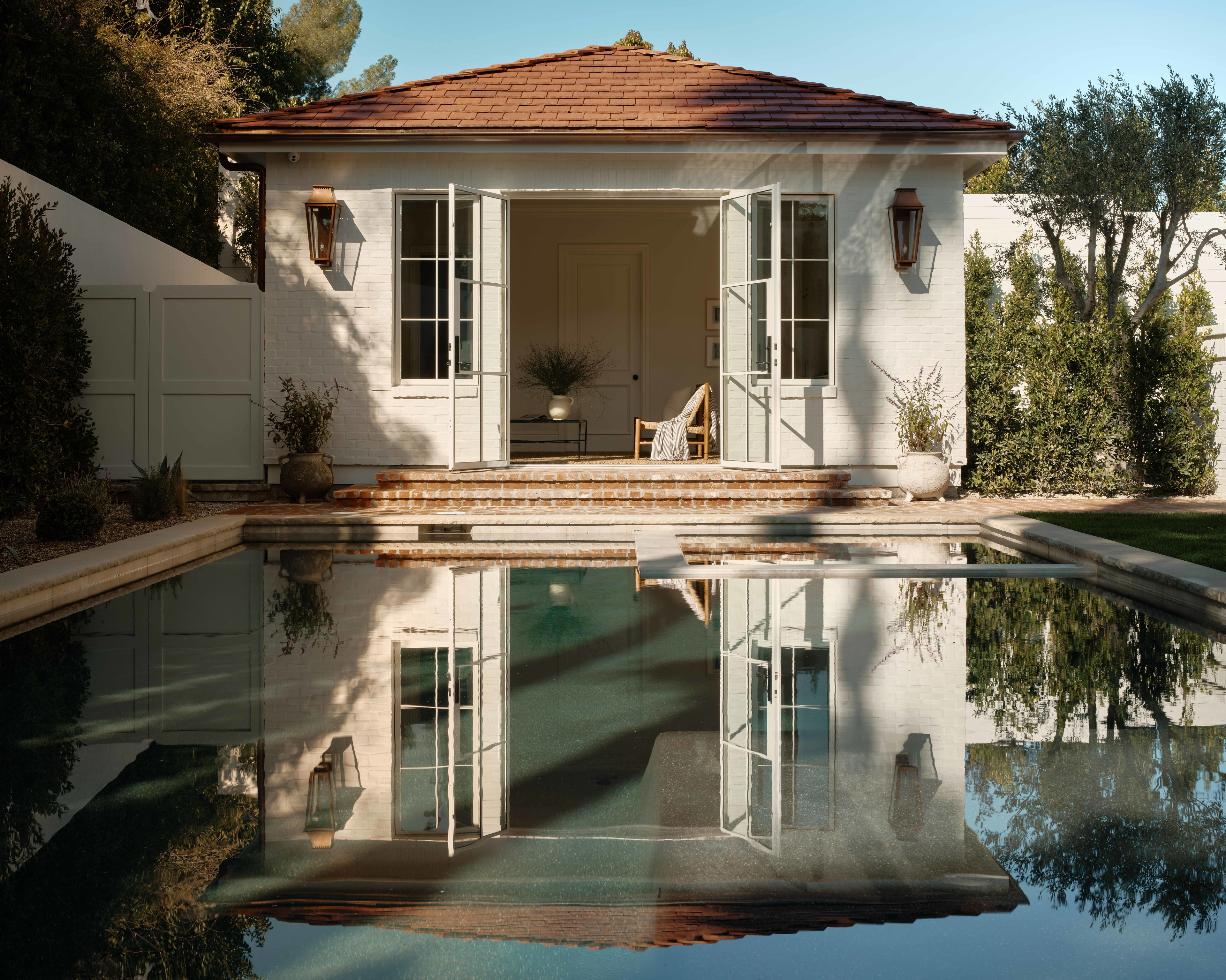 a house with a pool in front of it