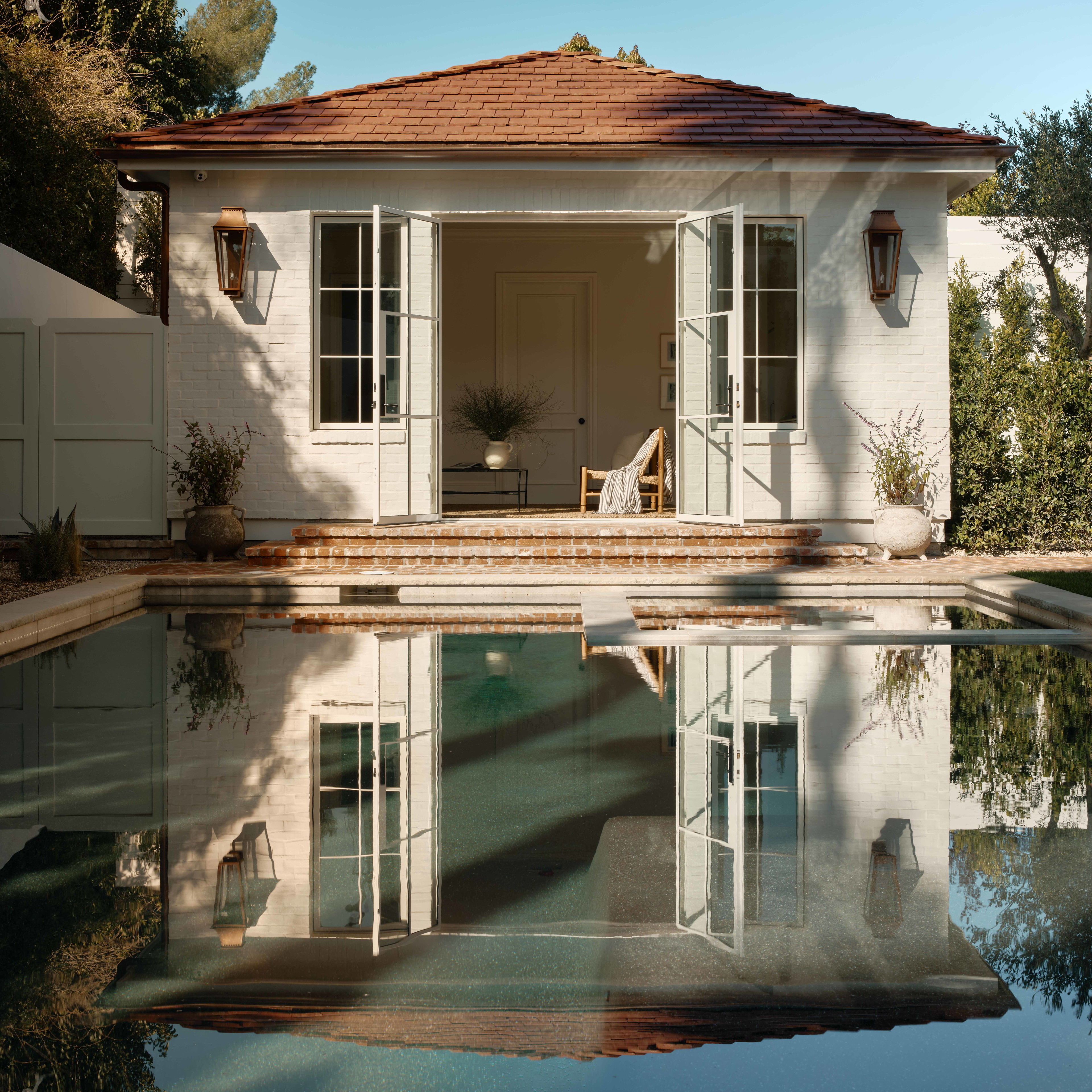 a house with a pool in front of it