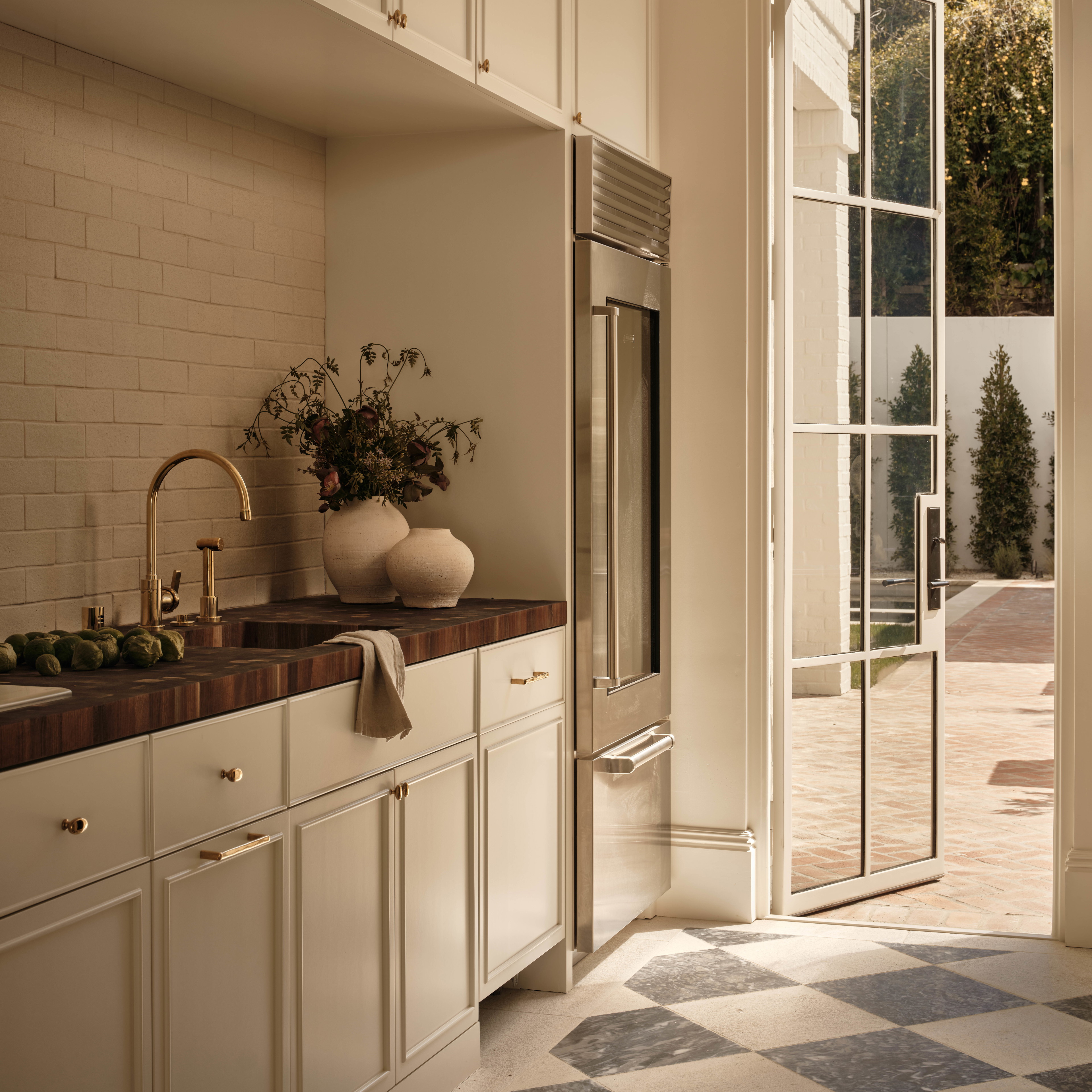 a kitchen with a checkered floor and a large window