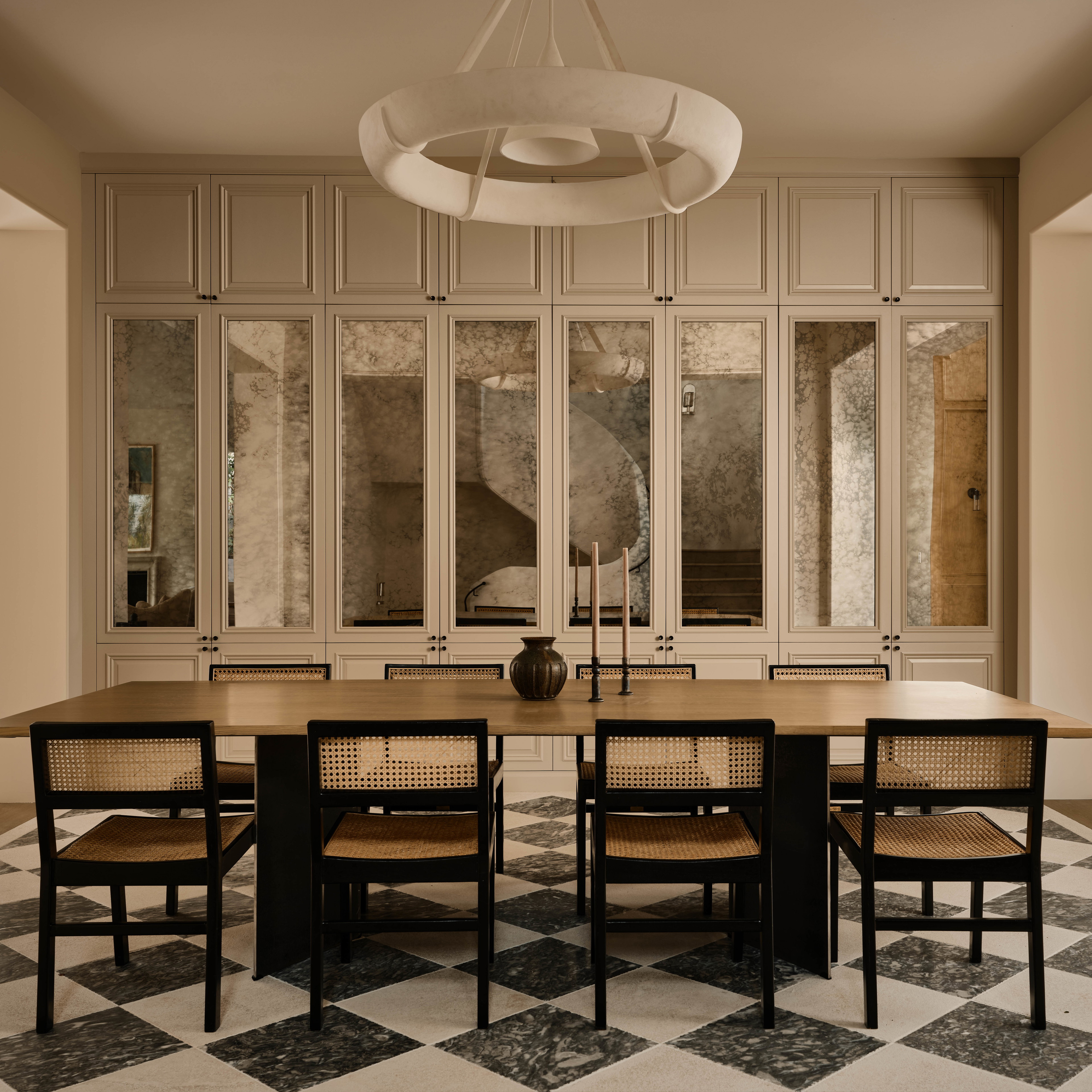 a dining room with a checkered floor and a chandelier