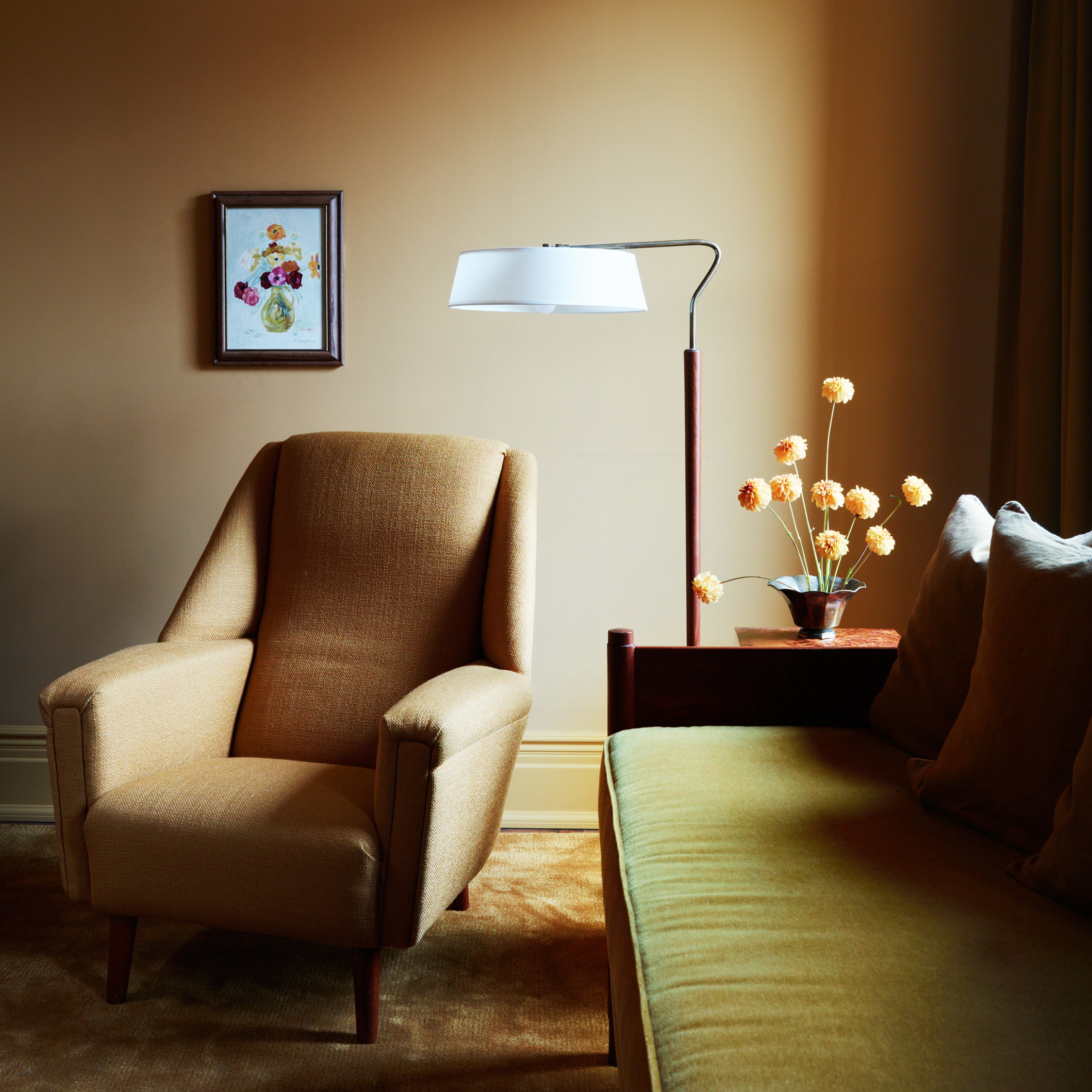 a living room with a couch, chair and lamp