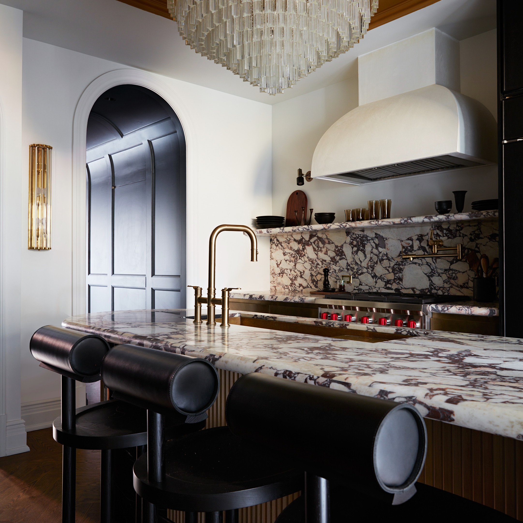 a kitchen with a chandelier hanging from the ceiling