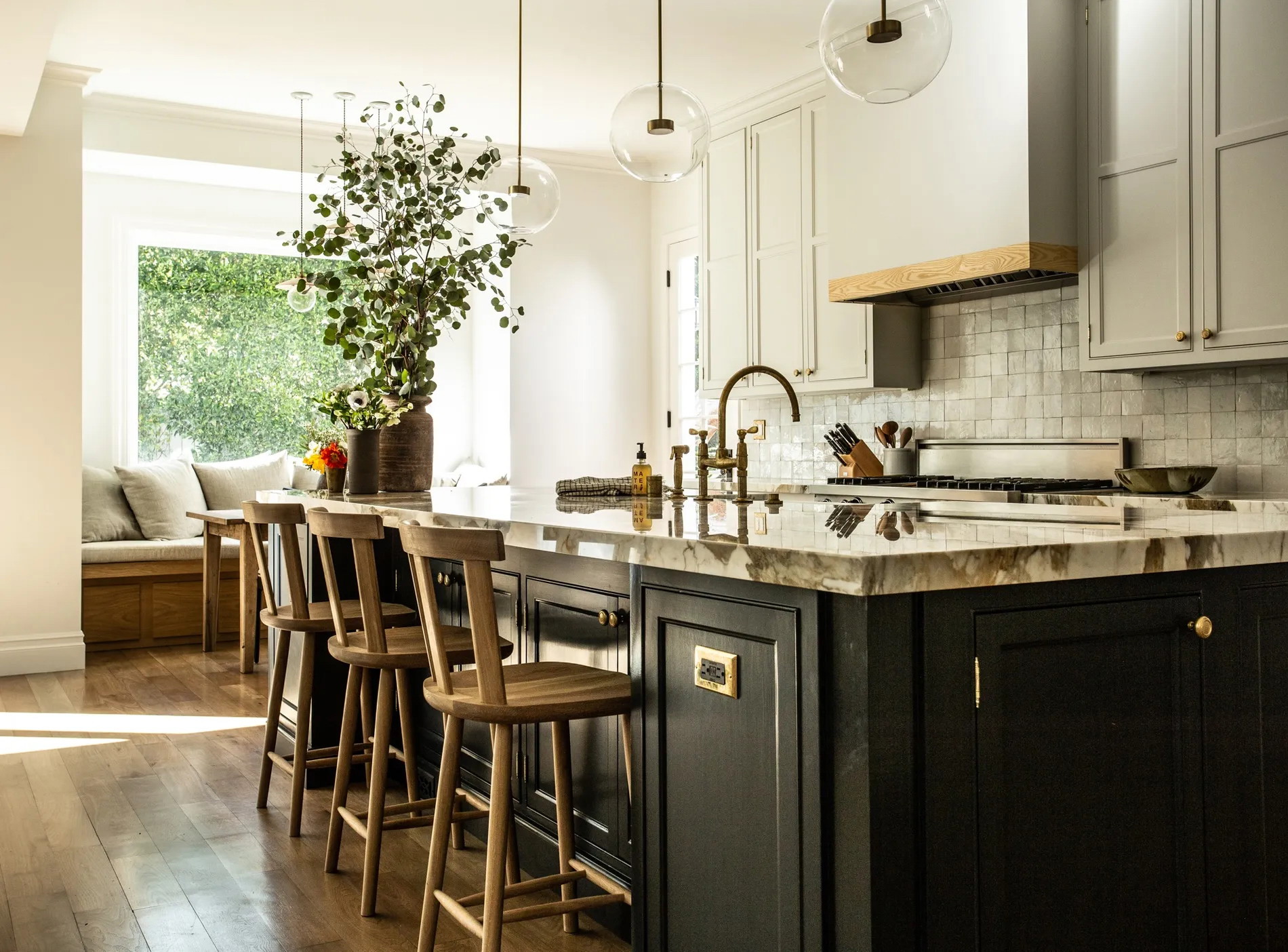 a large kitchen with a center island and bar stools