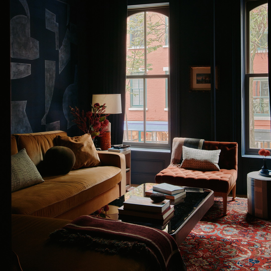 a living room filled with furniture and a large window