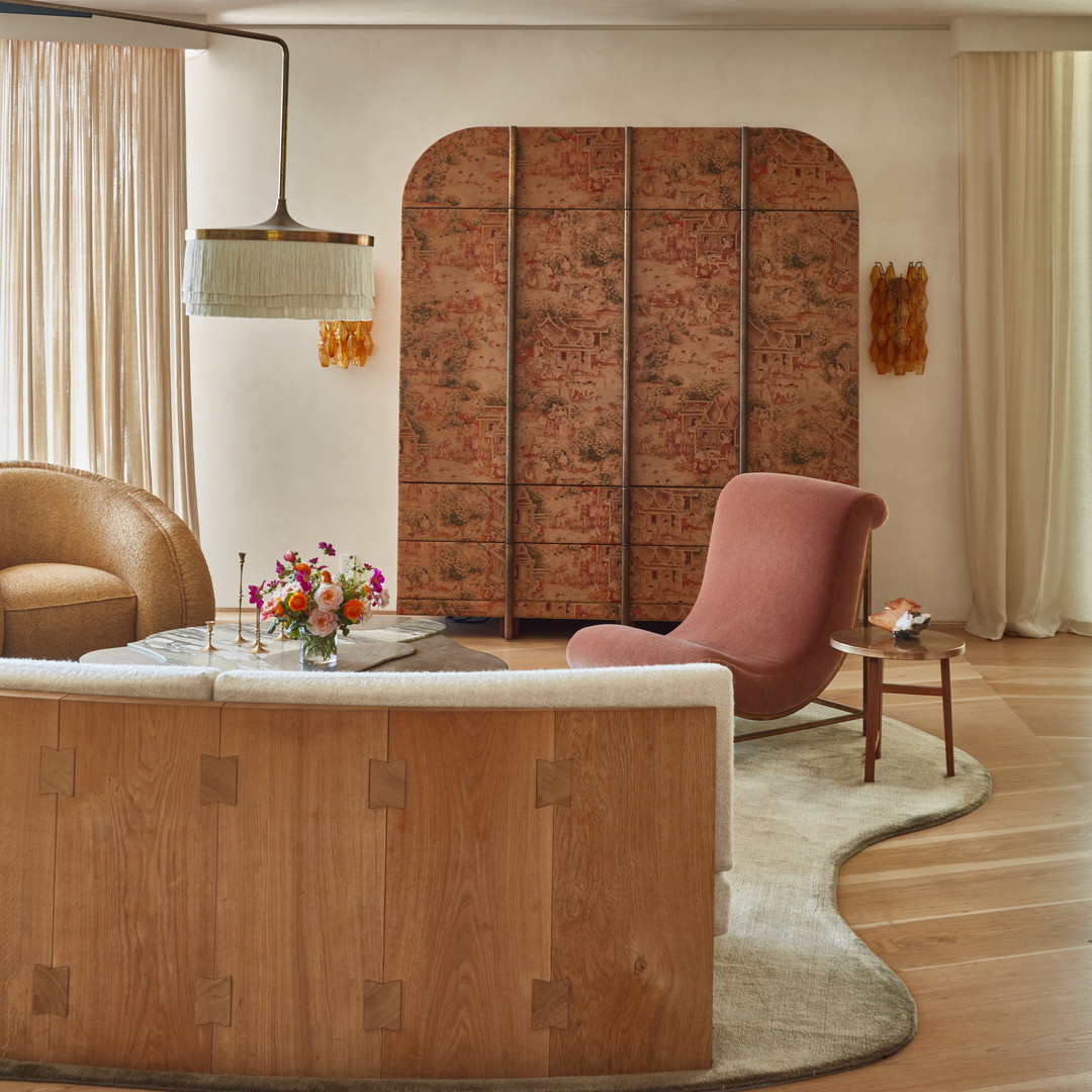 a living room filled with furniture and a wooden table