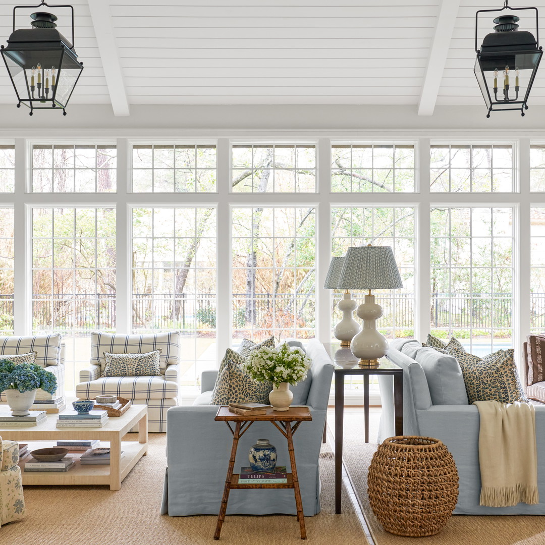 a living room filled with furniture and lots of windows