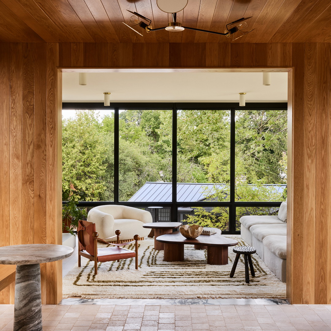 a living room filled with furniture and a large window