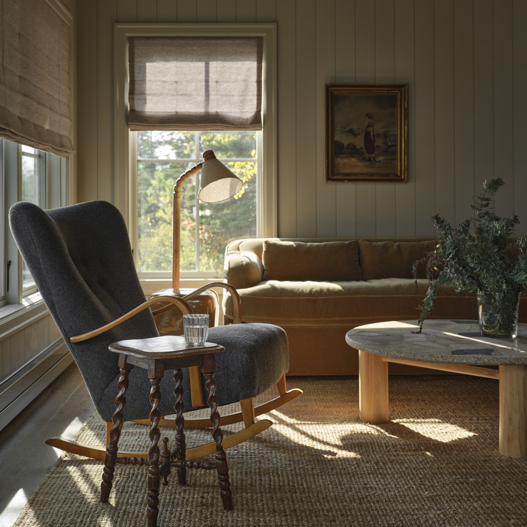 a living room filled with furniture and a window