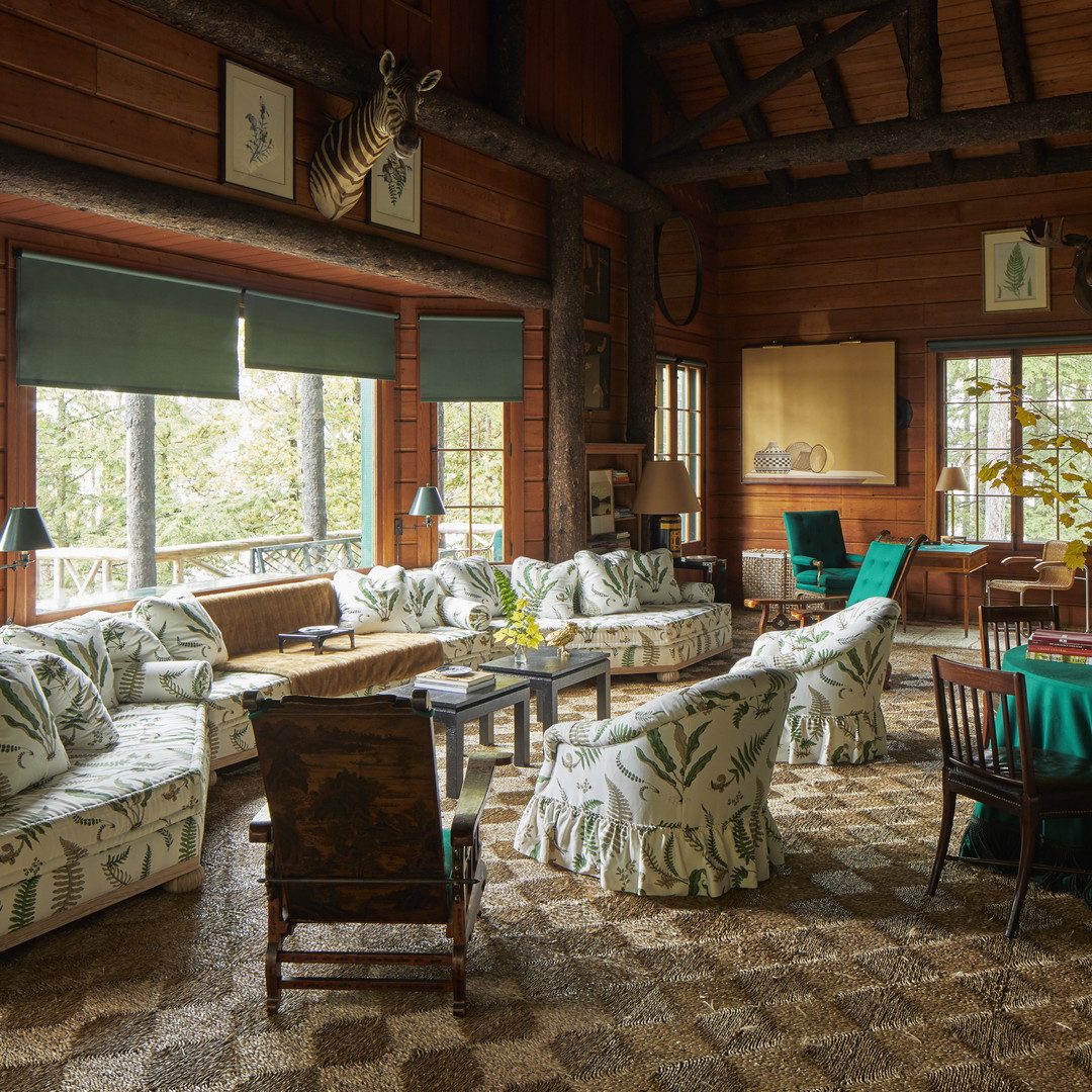 a living room filled with furniture and lots of windows