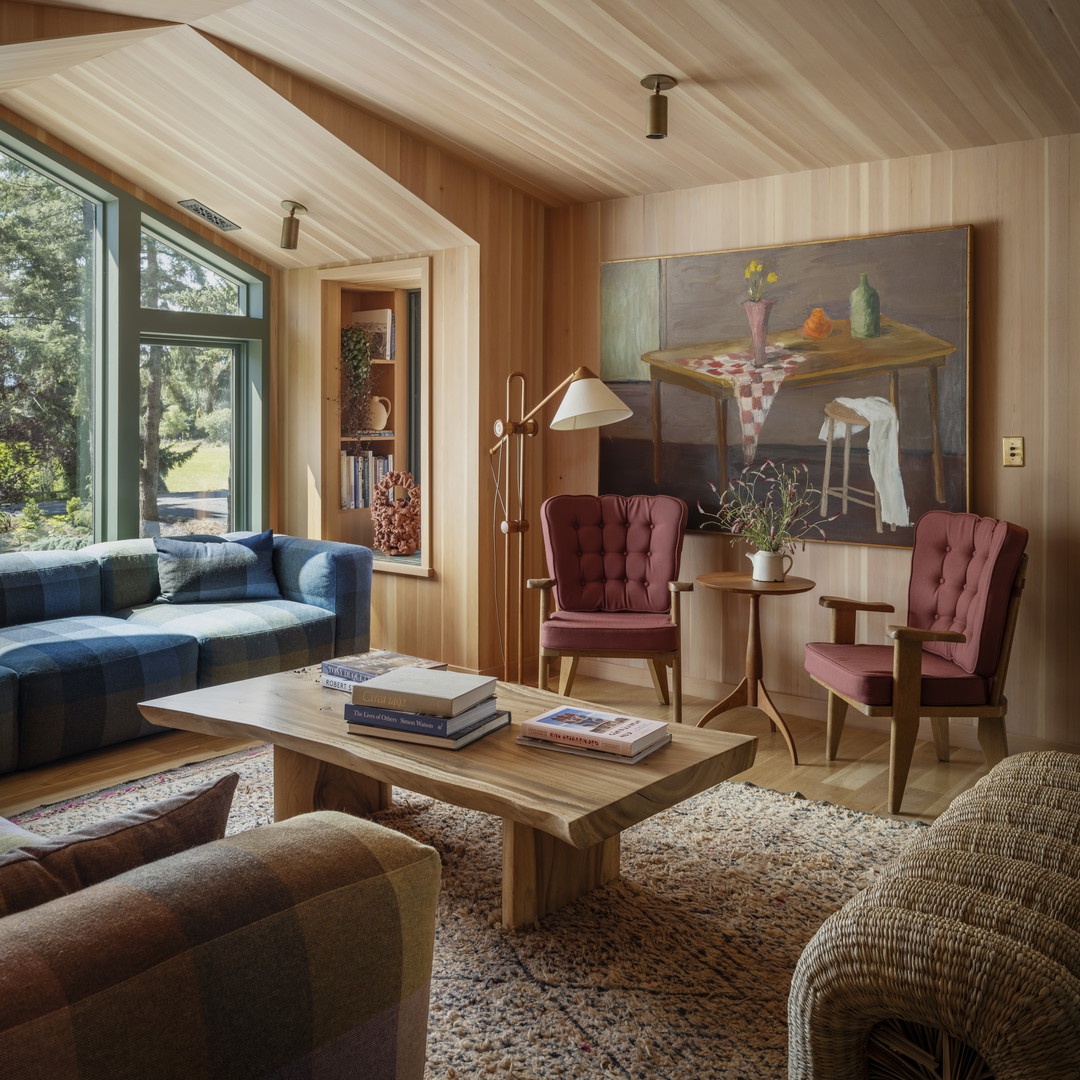 a living room filled with furniture and a large window