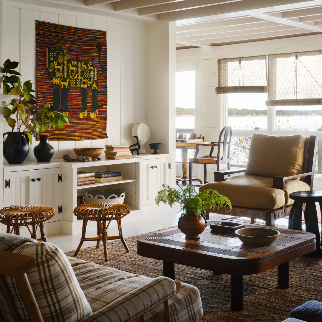 a living room filled with furniture and a painting on the wall