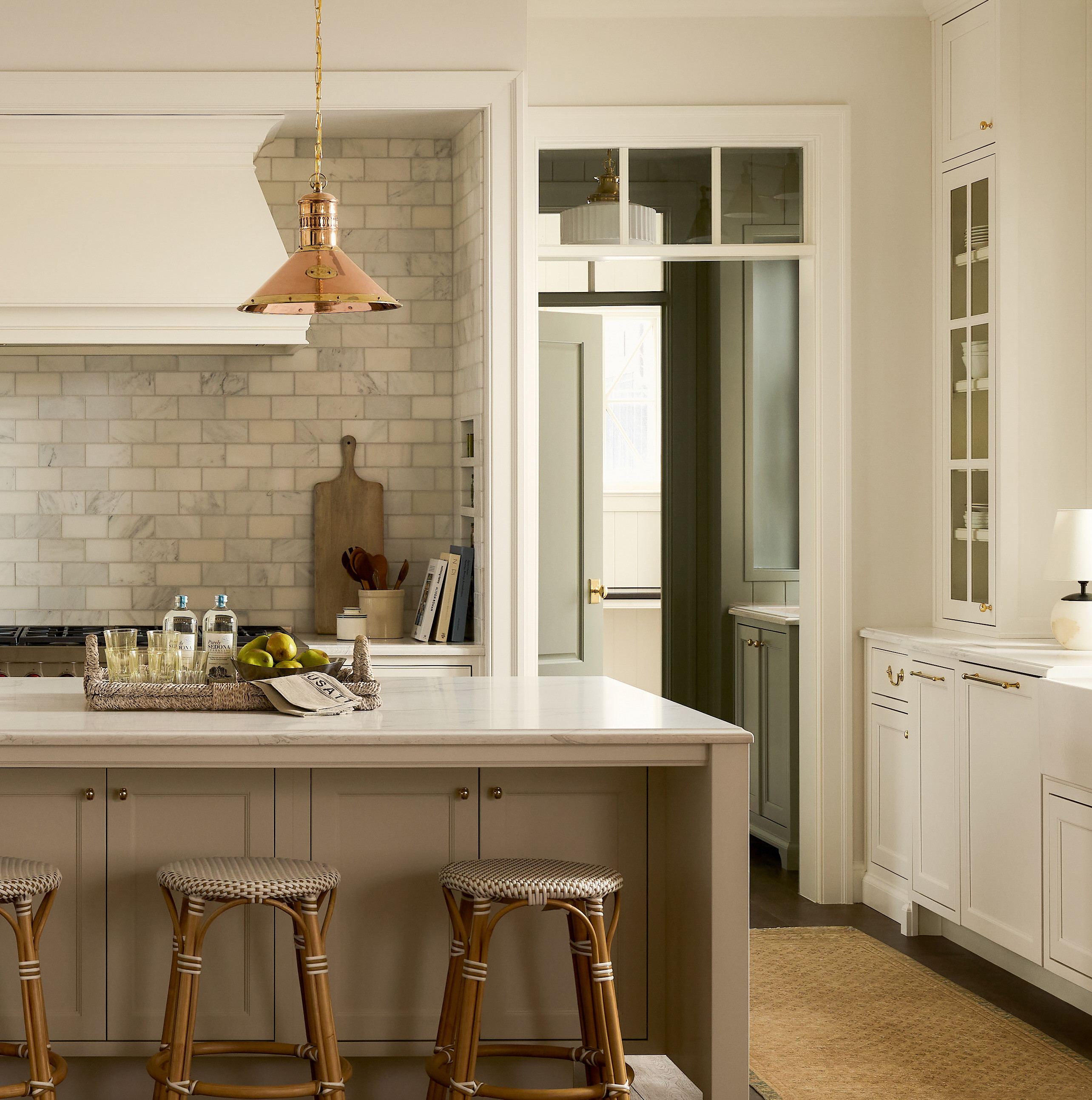 a kitchen with two stools and a center island