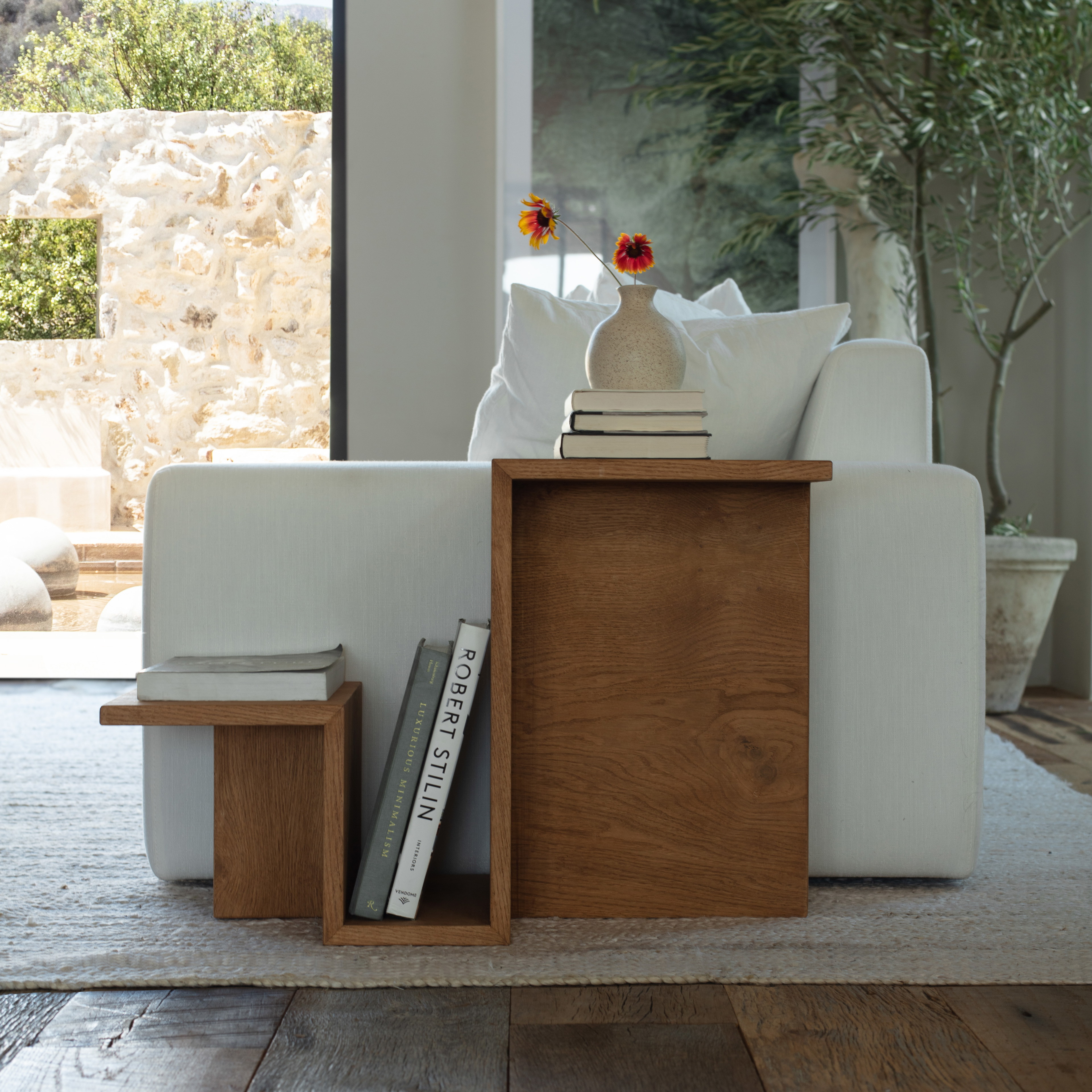 a living room with a white couch and a wooden table