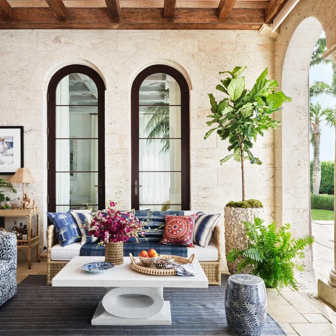 a living room filled with furniture and a potted plant