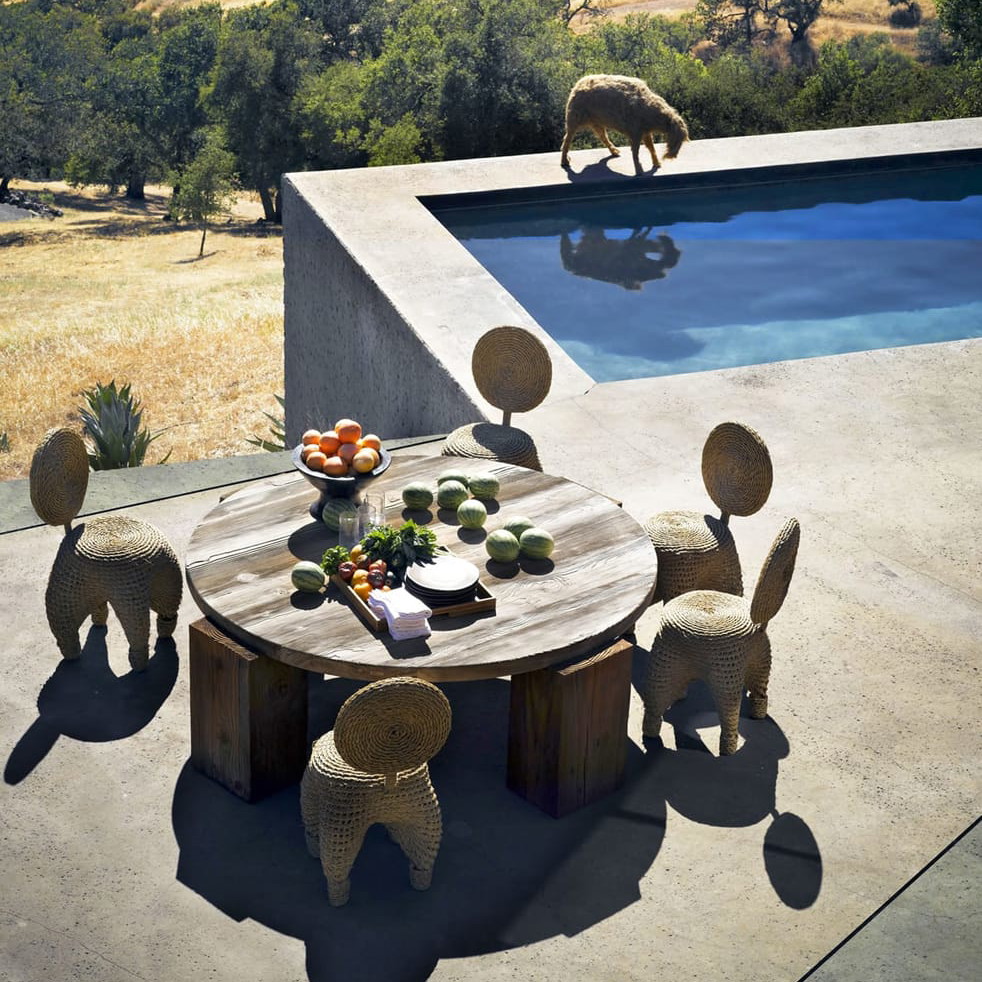 a table with fruit on it next to a pool