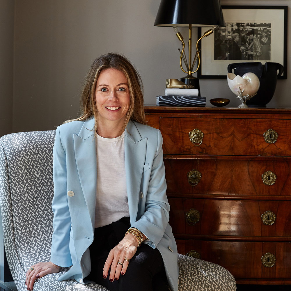 a woman sitting on a chair in a room